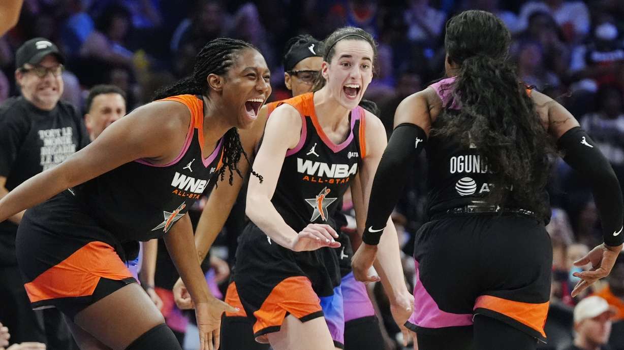 Arike Ogunbowale, right, of Team WNBA, celebrates after her 3-point basket against Team USA with teammates Caitlin Clark, center, and Aliyah Boston, left, during the second half of a WNBA All-Star basketball game Saturday, July 20, 2024, in Phoenix.