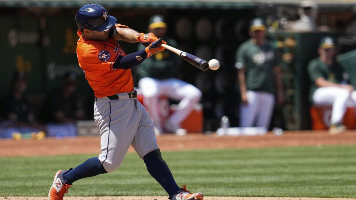 Houston Astros' Jose Altuve hits an RBI double against the Oakland Athletics during the seventh inning of a baseball game, Wednesday, July 24, 2024, in Oakland, Calif.