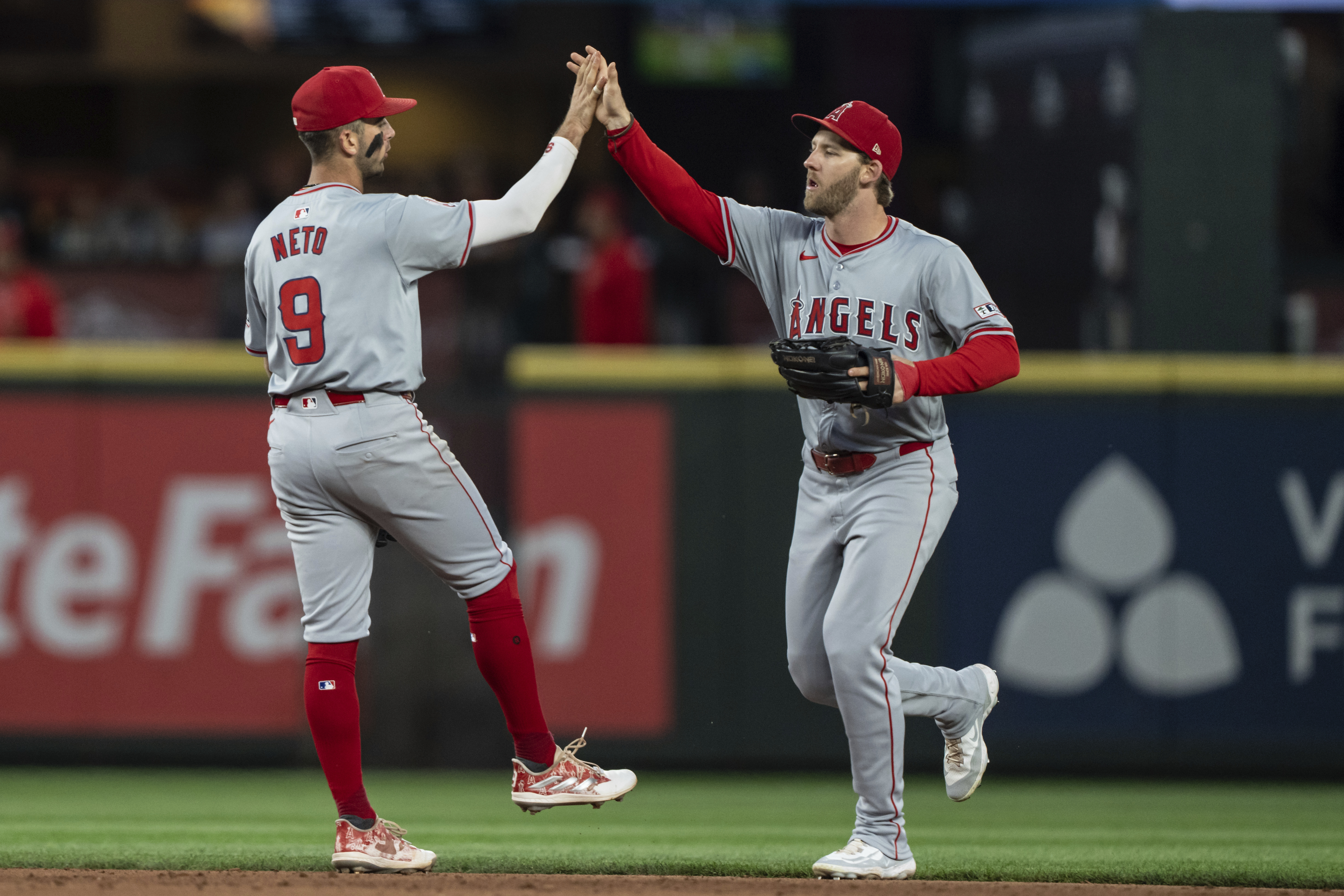 Los Angeles Angels' Zach Neto, left, and Taylor Ward celebrate after a baseball game against the Seattle Mariners, Tuesday, July 23, 2024, in Seattle. 