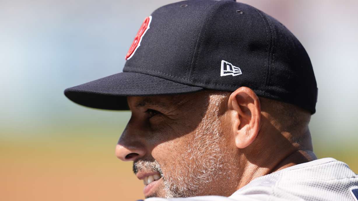 Boston Red Sox manager Alex Cora watches from the dugout during the first inning of a baseball game against the Los Angeles Dodgers, Saturday, July 20, 2024, in Los Angeles.