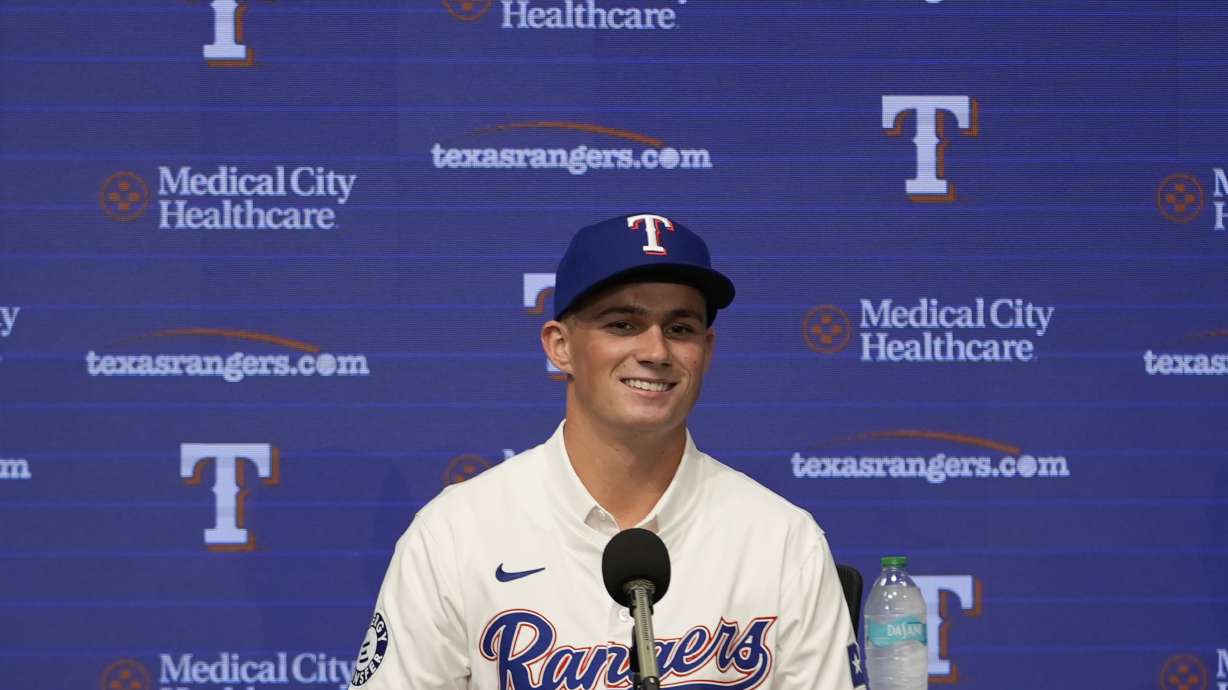 Texas Rangers first round draft pick catcher Malcolm Moore smiles during a news conference in Arlington, Texas, Wednesday, July 24, 2024.
