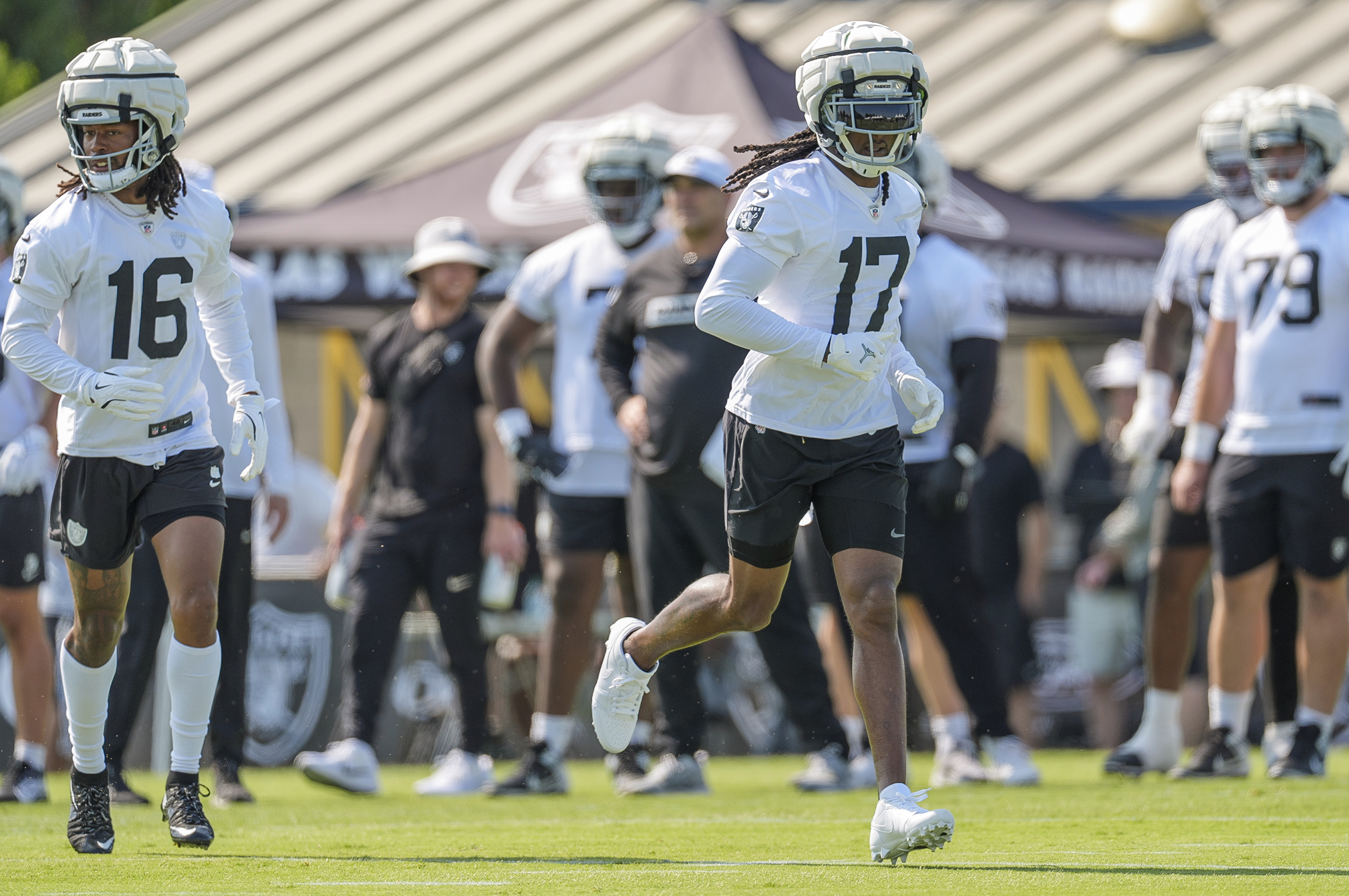 Las Vegas Raiders wide receiver Jakobi Meyers (16), and Las Vegas Raiders wide receiver Davante Adams (17) run during NFL football training camp at Jack R. Hammett Sports Complex in Costa Mesa, Calif., Wednesday, July 24, 2024. 