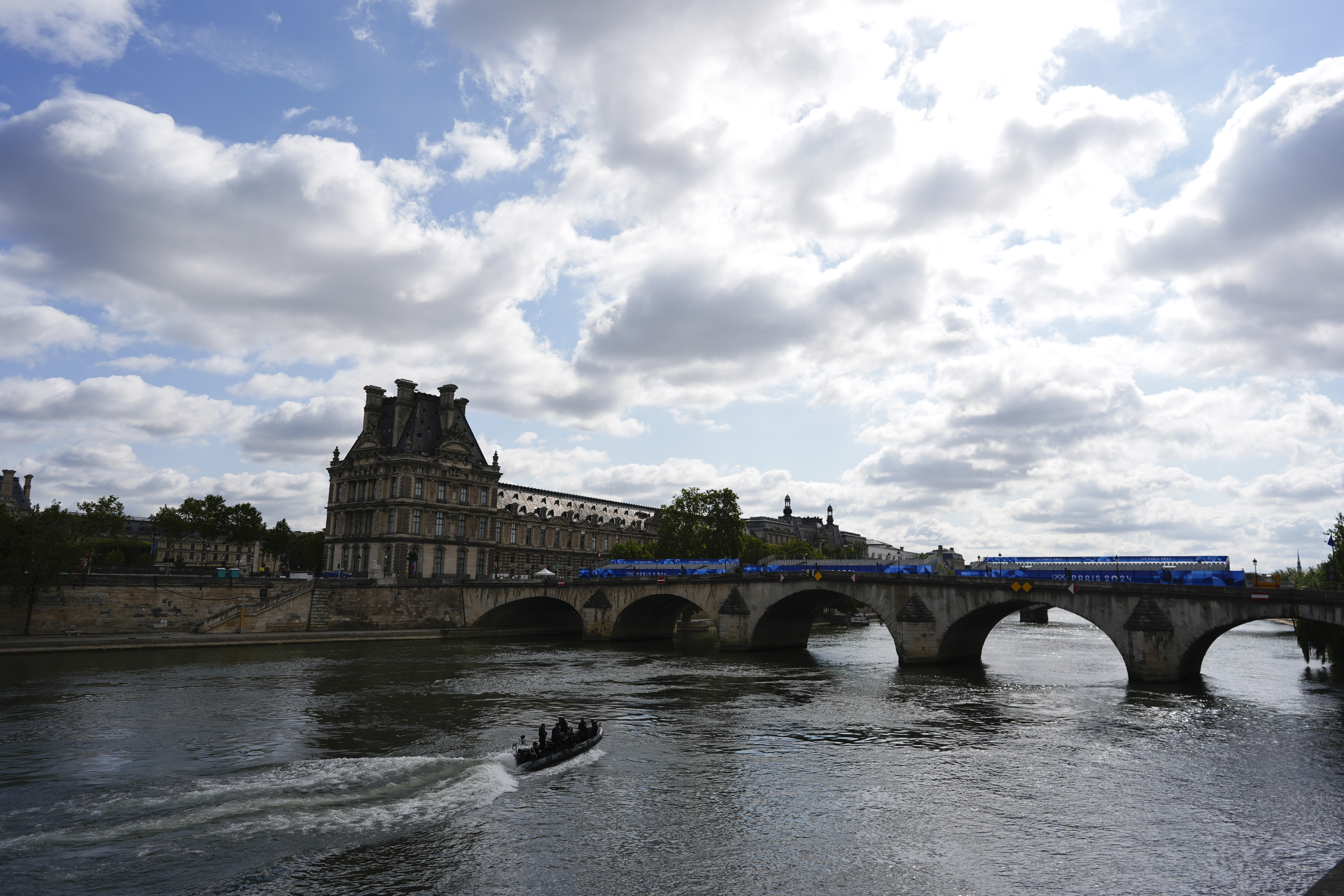 A bomb squad boat navigates the Seine River as officials prepare for Friday's opening ceremony, ahead of the 2024 Summer Olympics, Monday, July 22, 2024, in Paris, France. 