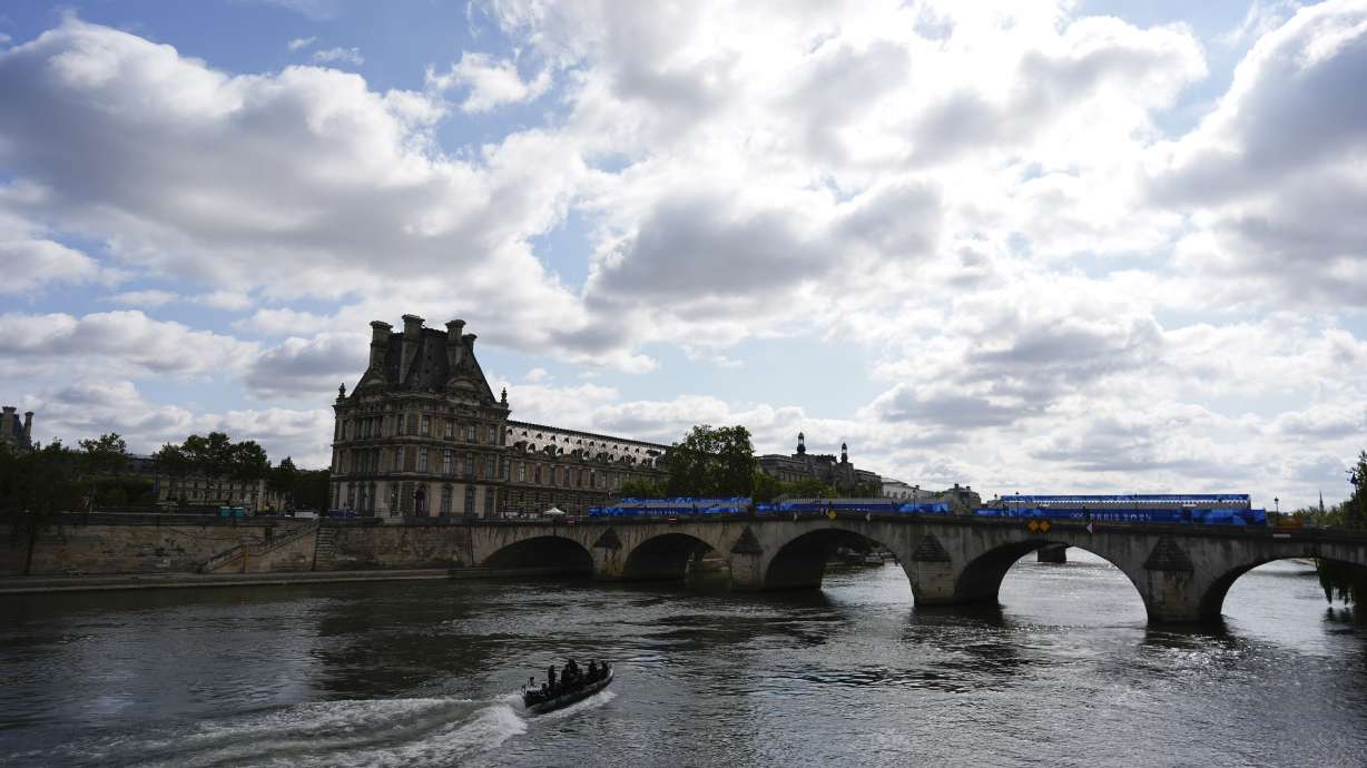 A bomb squad boat navigates the Seine River as officials prepare for Friday's opening ceremony, ahead of the 2024 Summer Olympics, Monday, July 22, 2024, in Paris, France.