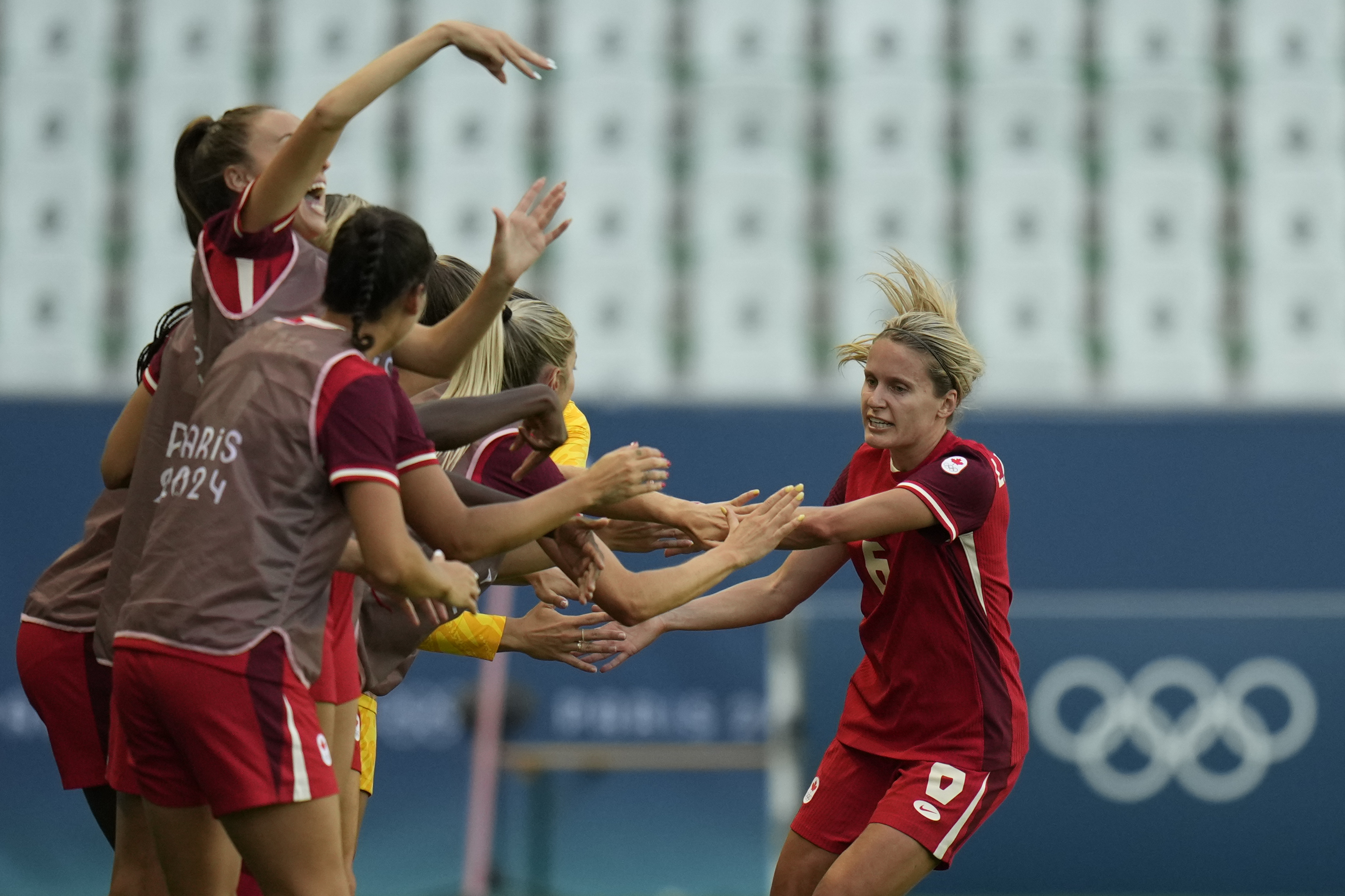 Canada's Cloe Lacasse, right, is congratulated after scoring her side's first goal during the women's Group A soccer match between Canada and New Zealand at Geoffroy-Guichard stadium during the 2024 Summer Olympics, Thursday, July 25, 2024, in Saint-Etienne, France.