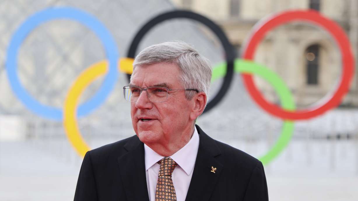 Thomas Bach, left, President of the International Olympic Committee (IOC) waits for guests before a gala dinner at the Louvre Museum, at the Paris Olympic games,Thursday, July 25, 2024 in Paris, France.