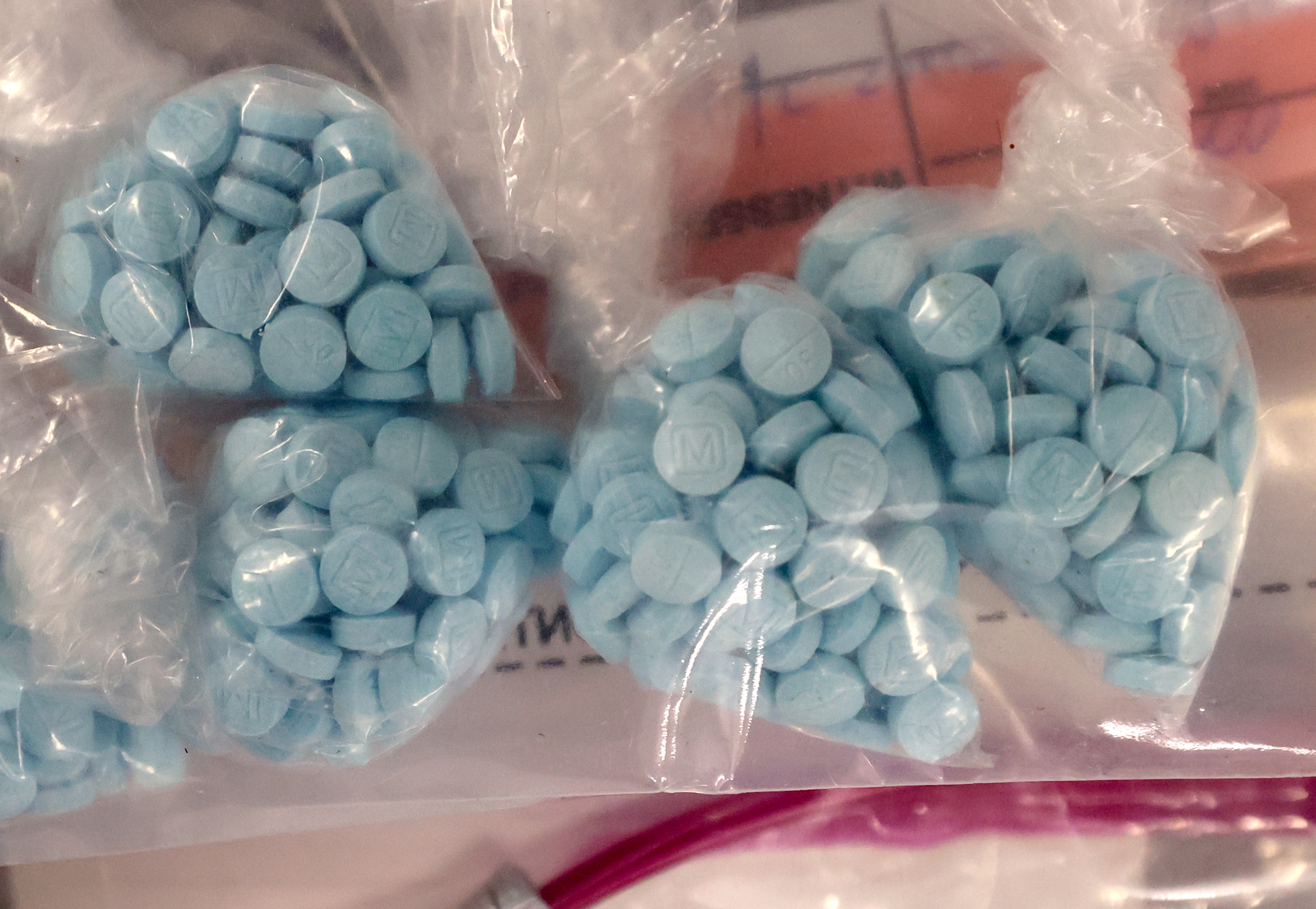 Seized fentanyl pills are displayed during a press conference about the dangers and increase in fentanyl at the Drug Enforcement Administration Salt Lake City District Office in Salt Lake City on Thursday. The pills are marked to look like authentic pharmaceutical drugs but are fake and can be deadly.