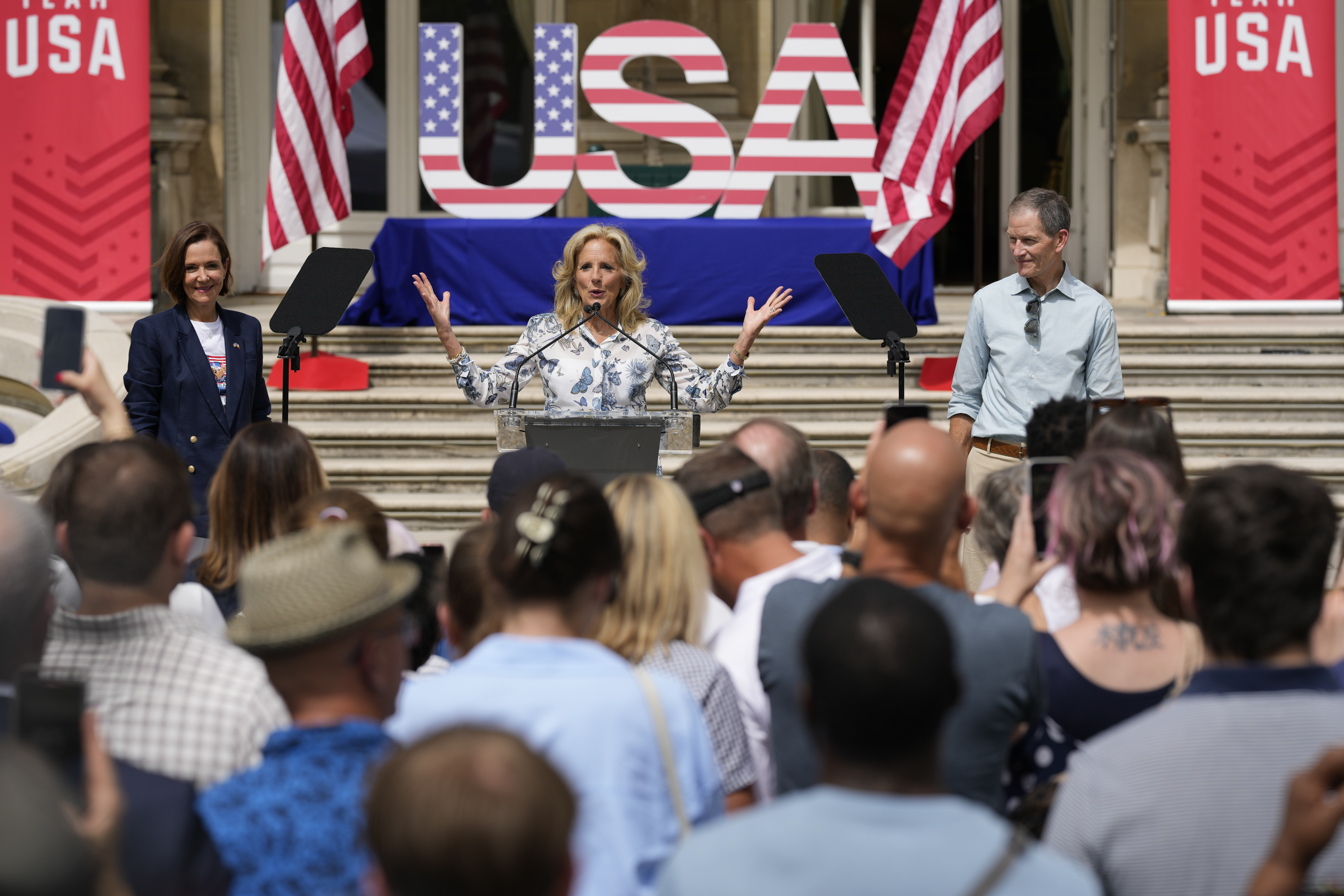 First lady Jill Biden, center, delivers remarks to family members of Team USA with U.S. Ambassador to France, Denise Campbell Bauer, left, and Gene Sykes, chairman of the U.S. Olympic & Paralympic Committee, right, at the ambassador's residence during the 2024 Summer Olympics, Thursday, July 25, 2024, in Paris, France. 