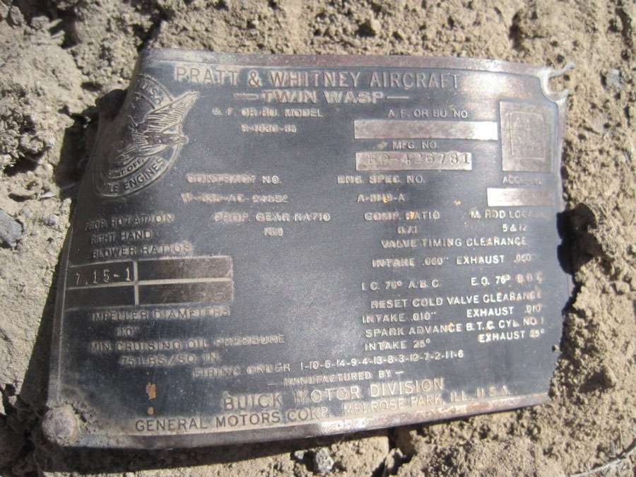An undated photo shows an engine data plate found at the crash site.
