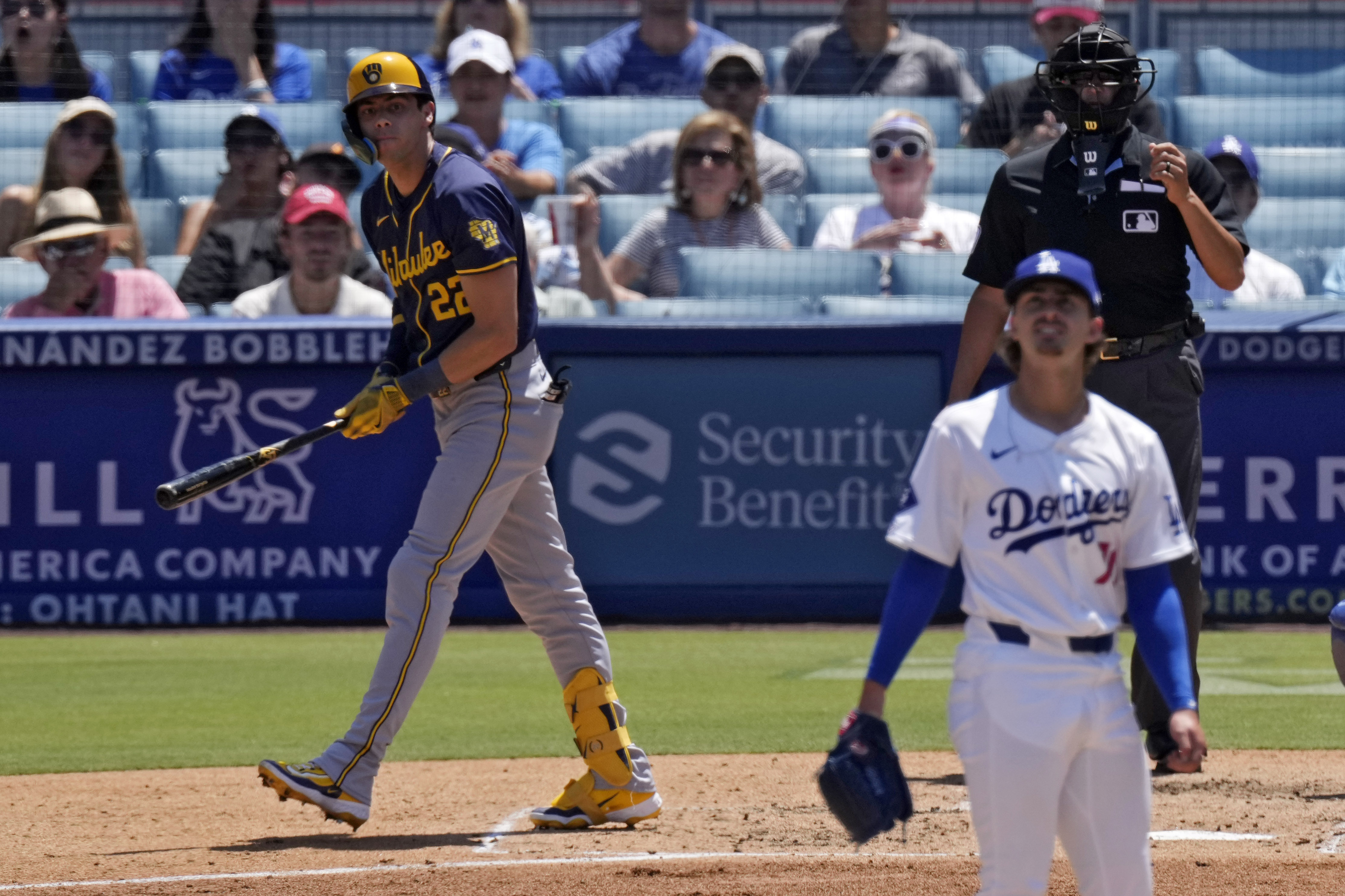 Milwaukee Brewers' Christian Yelich, left, heads to first for a two-run home run as Los Angeles Dodgers starting pitcher Justin Wrobleski watches during the fourth inning of a baseball game Sunday, July 7, 2024, in Los Angeles. 