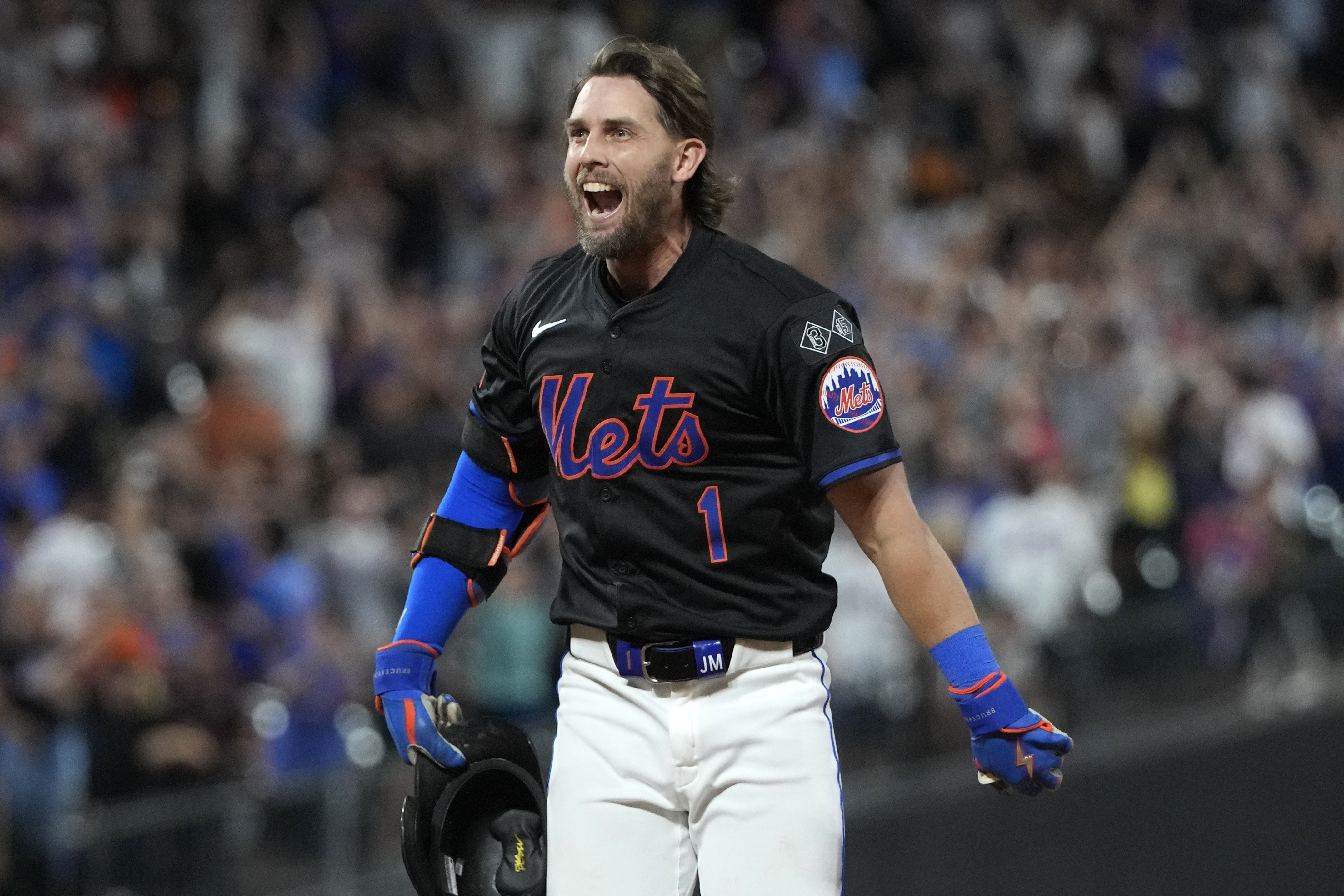 New York Mets' Jeff McNeil reacts after hitting a walkoff single leading Jose Iglesias to score during the 10th inning of a baseball game against the Atlanta Braves, Thursday, July 25, 2024, in New York.
