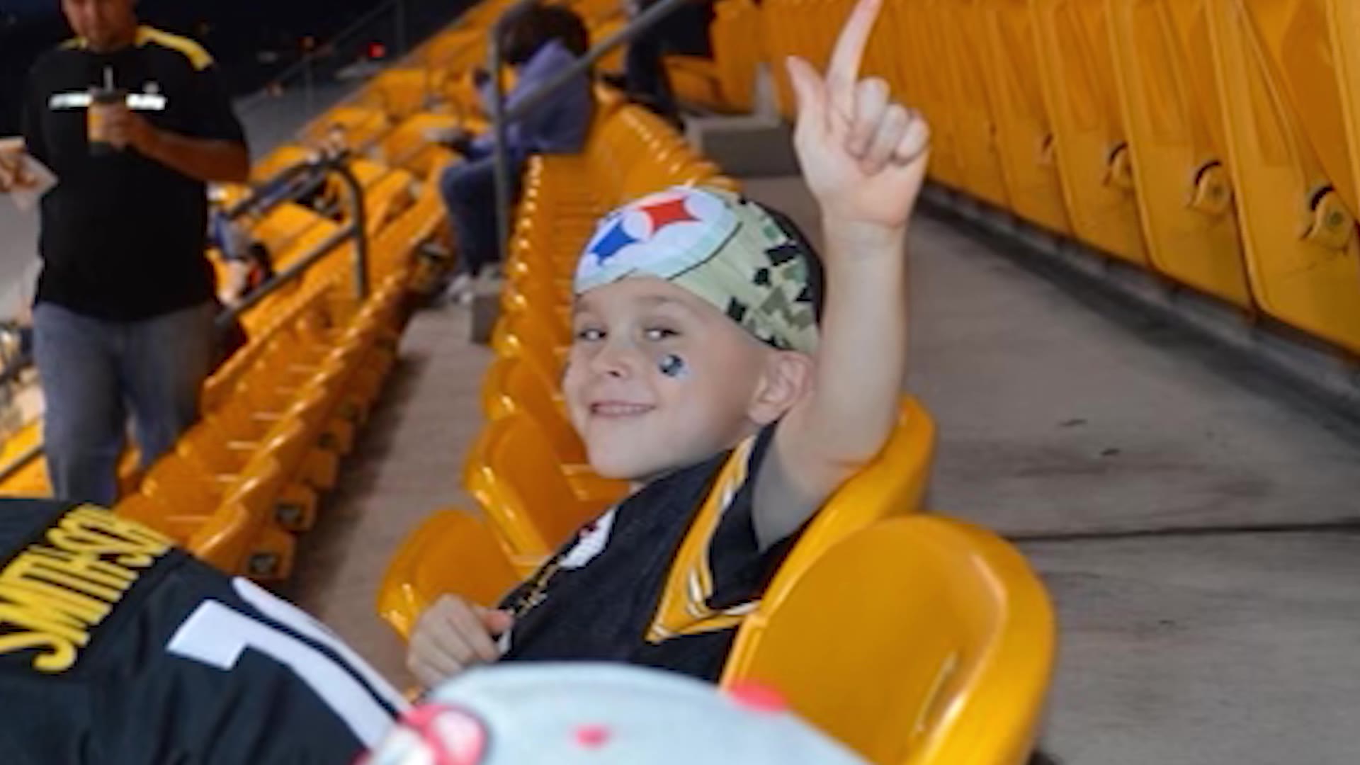 A young Gavin Peterson wearing sports gear at a stadium.