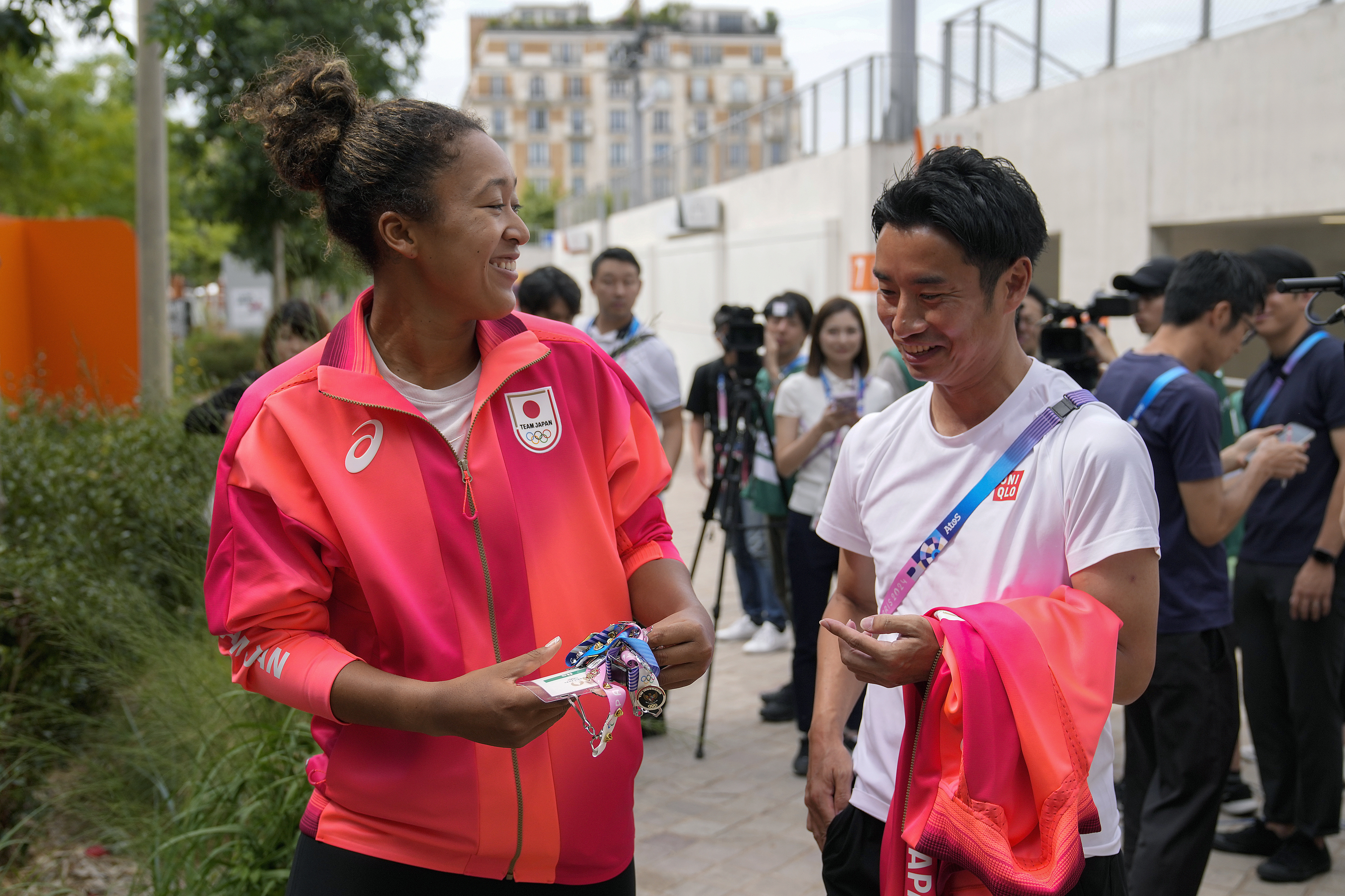 Naomi Osaka, of Japan, left, talks to a journalist after her practice session at the 2024 Summer Olympics, Thursday, July 25, 2024, in Paris, France.
