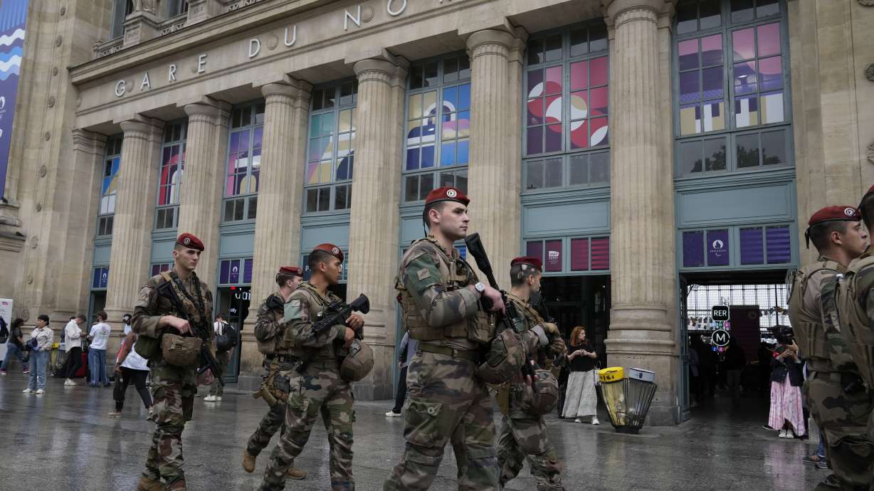 Soldiers patrol outside Gare du Nord train station at the 2024 Summer Olympics, Friday, July 26, 2024, in Paris, France. Hours away from the grand opening ceremony of the Olympics, high-speed rail traffic to the French capital was severely disrupted on Friday by what officials described as "criminal actions" and sabotage.