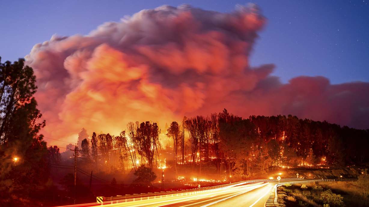 Seen in a long exposure photograph, the Park Fire burns along Highway 32 in the Forest Ranch community of Butte County, Calif., on Thursday.