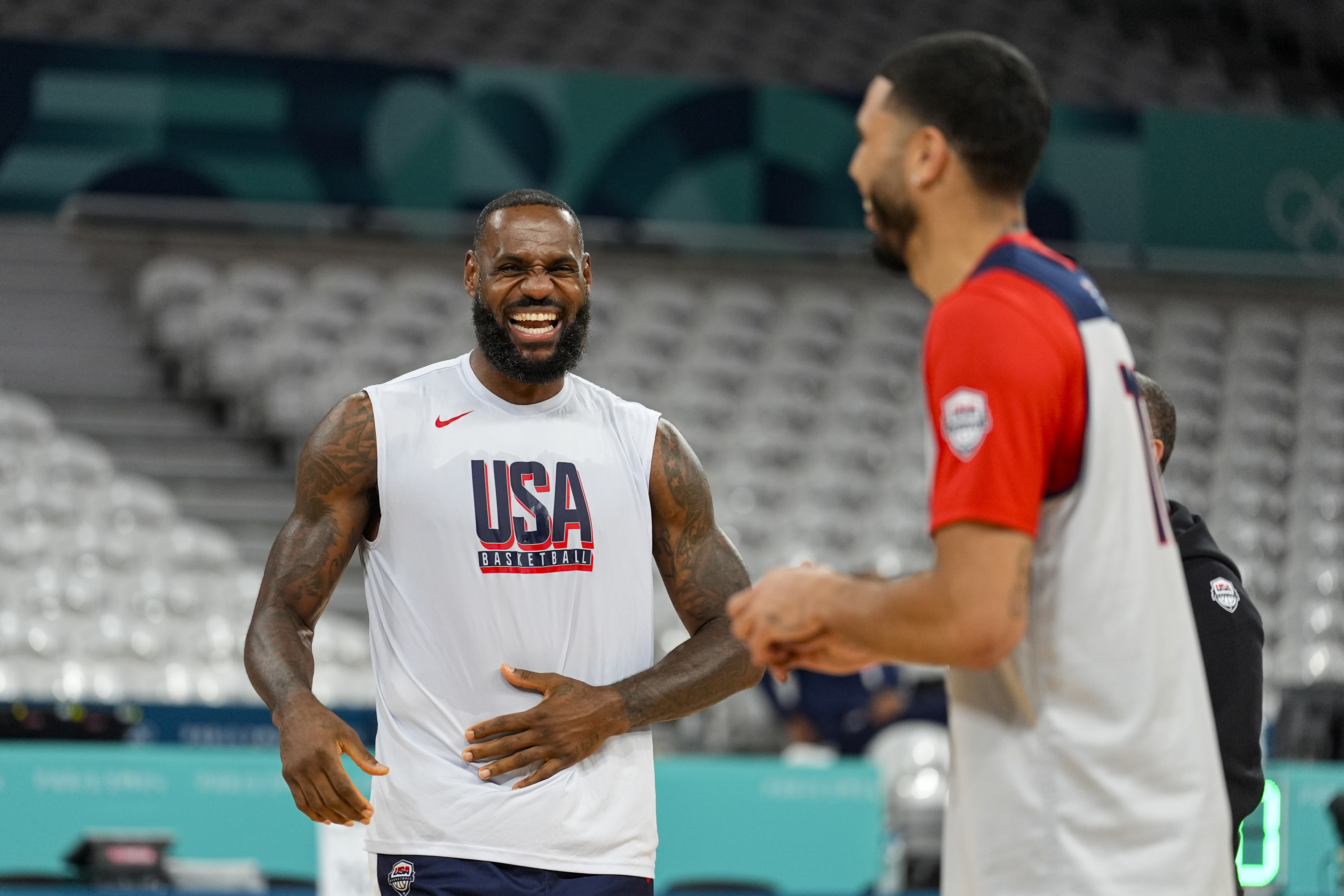 LeBron James, jokes with Jayson Tatum, as the United State's men's team practiced before the start of the basketball competition at the 2024 Summer Olympics, Wednesday, July 24, 2024 in Villeneuve-d'Ascq, France.
