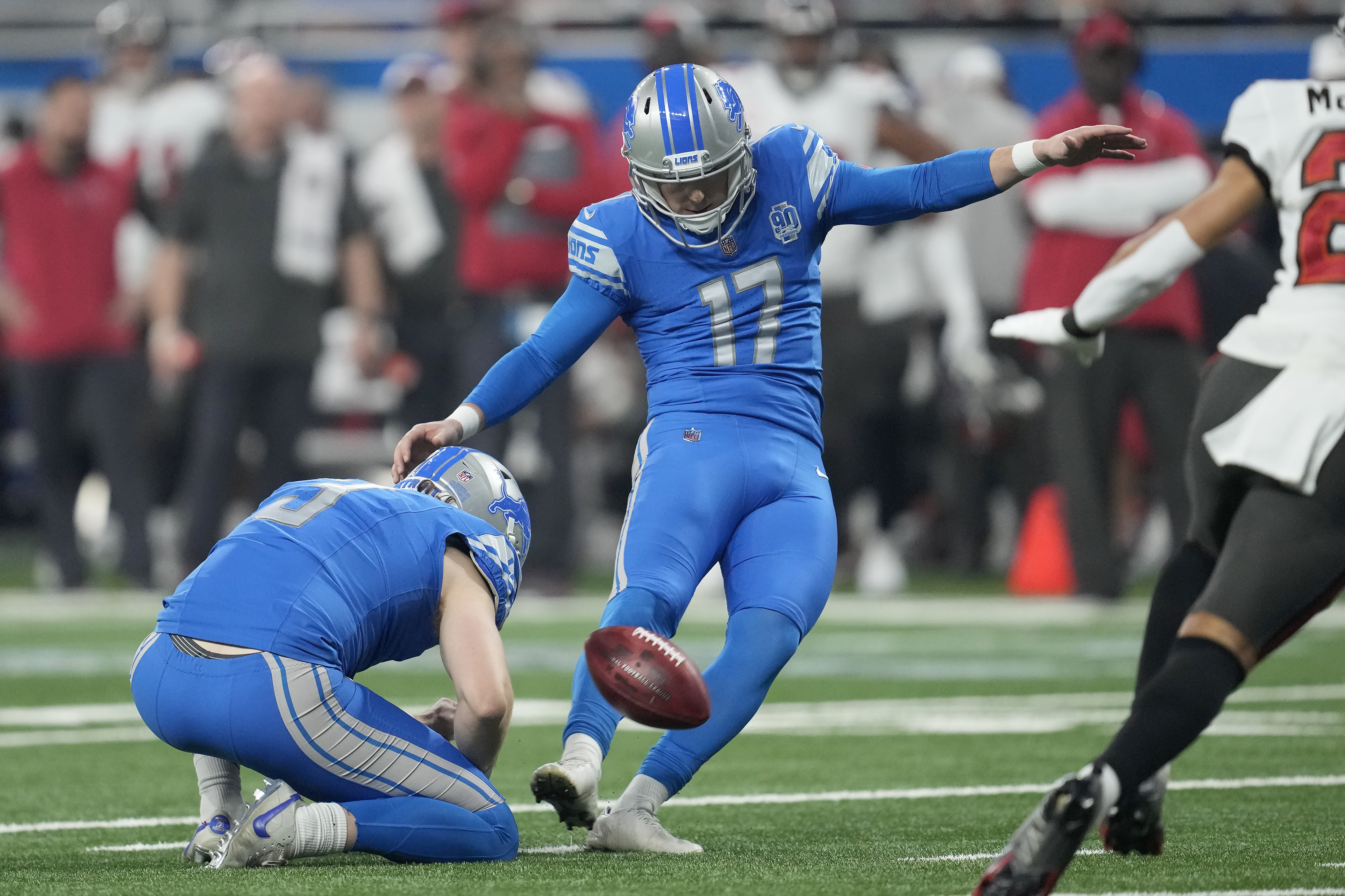 FILE - Detroit Lions place kicker Michael Badgley (17), with Jack Fox holding, kicks a field goal against the Tampa Bay Buccaneers during the first half of an NFL football NFC divisional playoff game, Sunday, Jan. 21, 2024, in Detroit. Badgley was injured before practice Thursday, July 26, 2204, and will require surgery. Coach Dan Campbell didn’t disclose the nature of the injury.