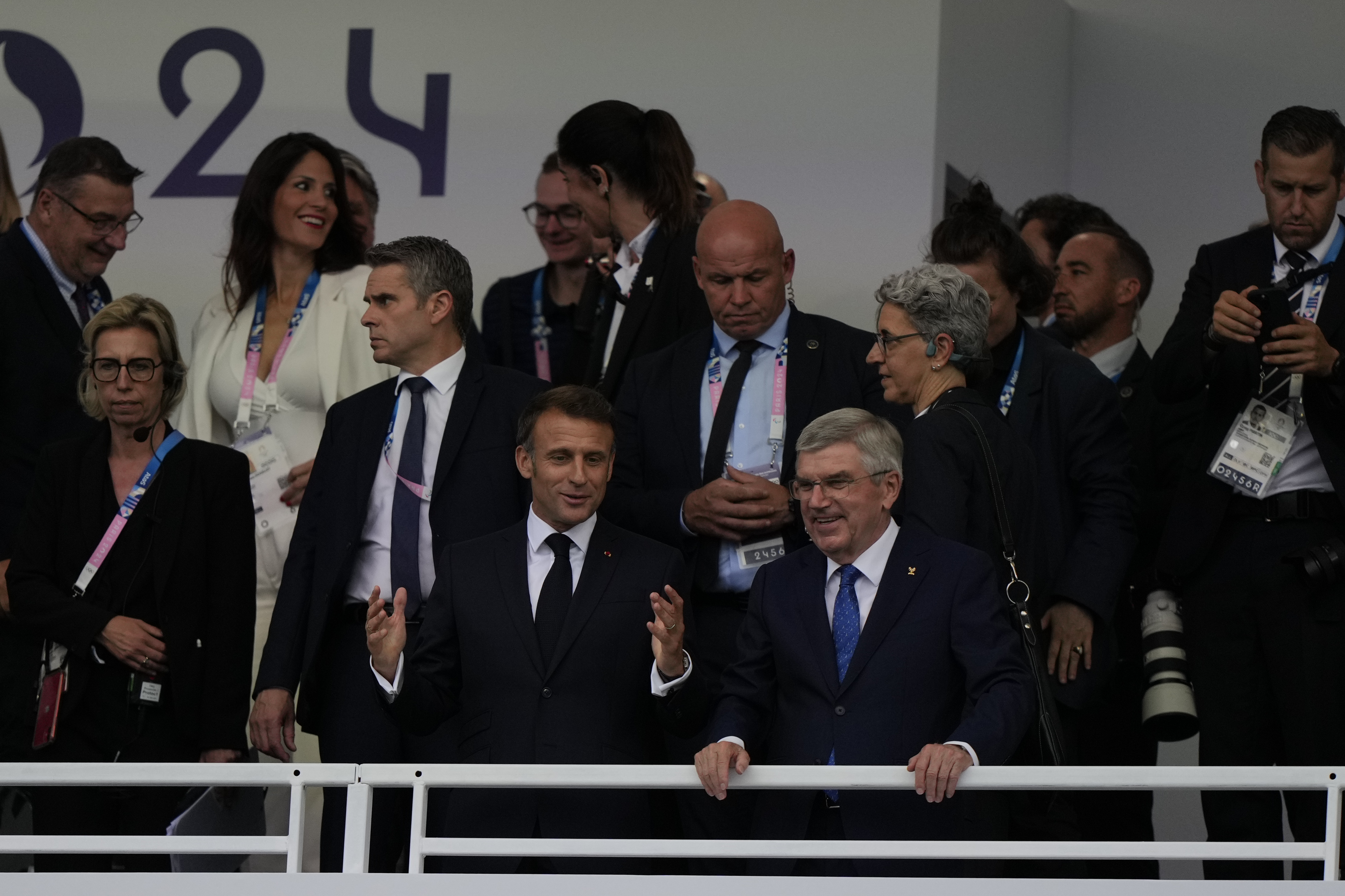 French President Emmanuel Macron, front left, and IOC President Thomas Bach in the stands in Paris, France, ahead of the opening ceremony of the 2024 Summer Olympics, Friday, July 26, 2024.