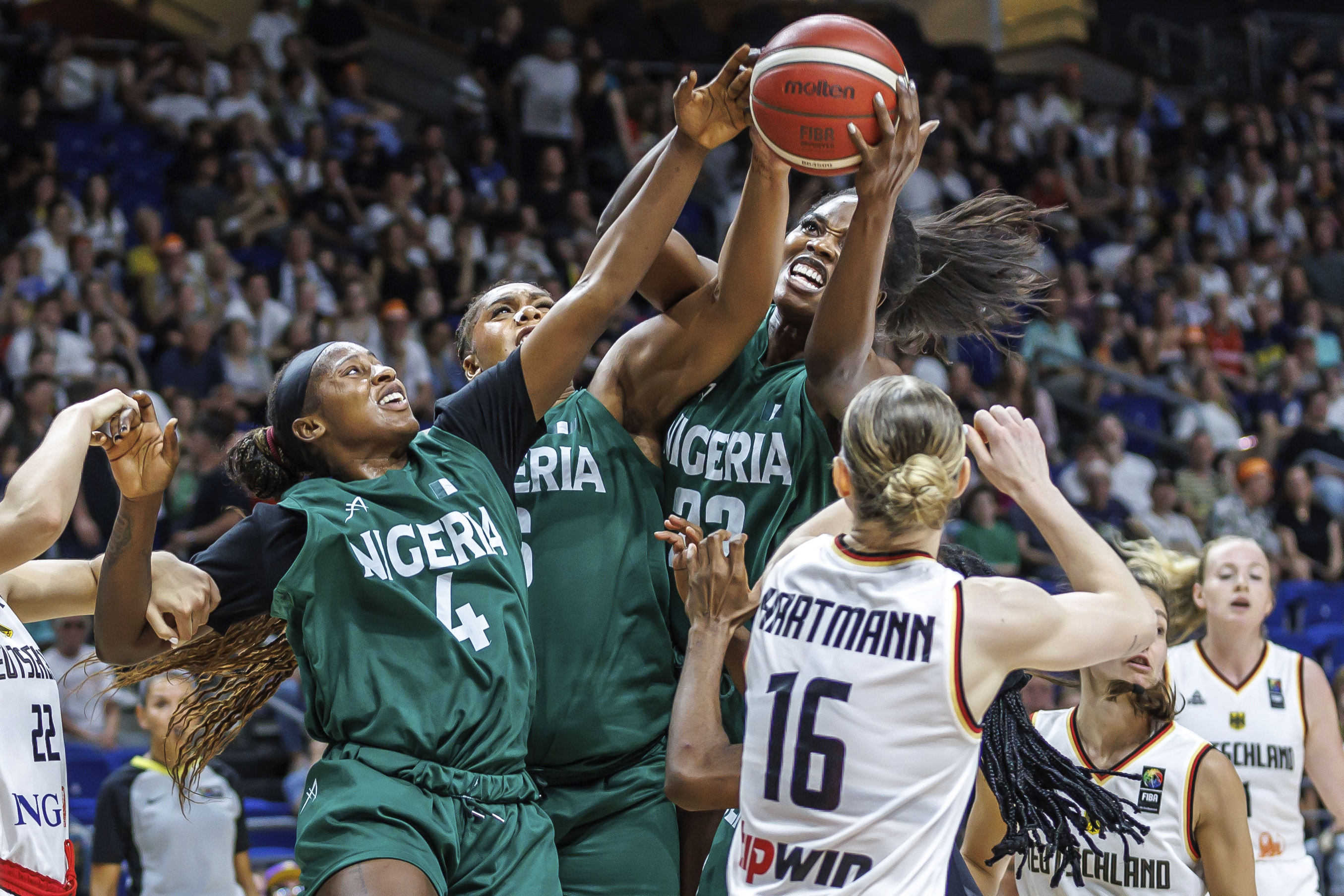 Germany's Alina Hartmann, right, tries to get the ball against, from right, Blessing Ejiofor, Lauren Ebo and Elizabeth Balogun from Nigeria during the Women International Basketball match between Germany and Nigeria at the Uber Arena in Berlin, Friday July 19, 2024.