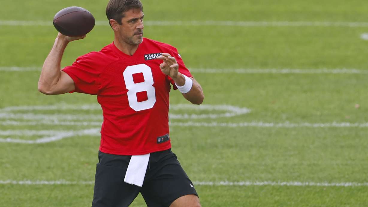 CORRECTS DATE: New York Jets quarterback Aaron Rodgers (8) throws during the team's NFL football training camp, Wednesday, July 24, 2024, in Florham Park, N.J.