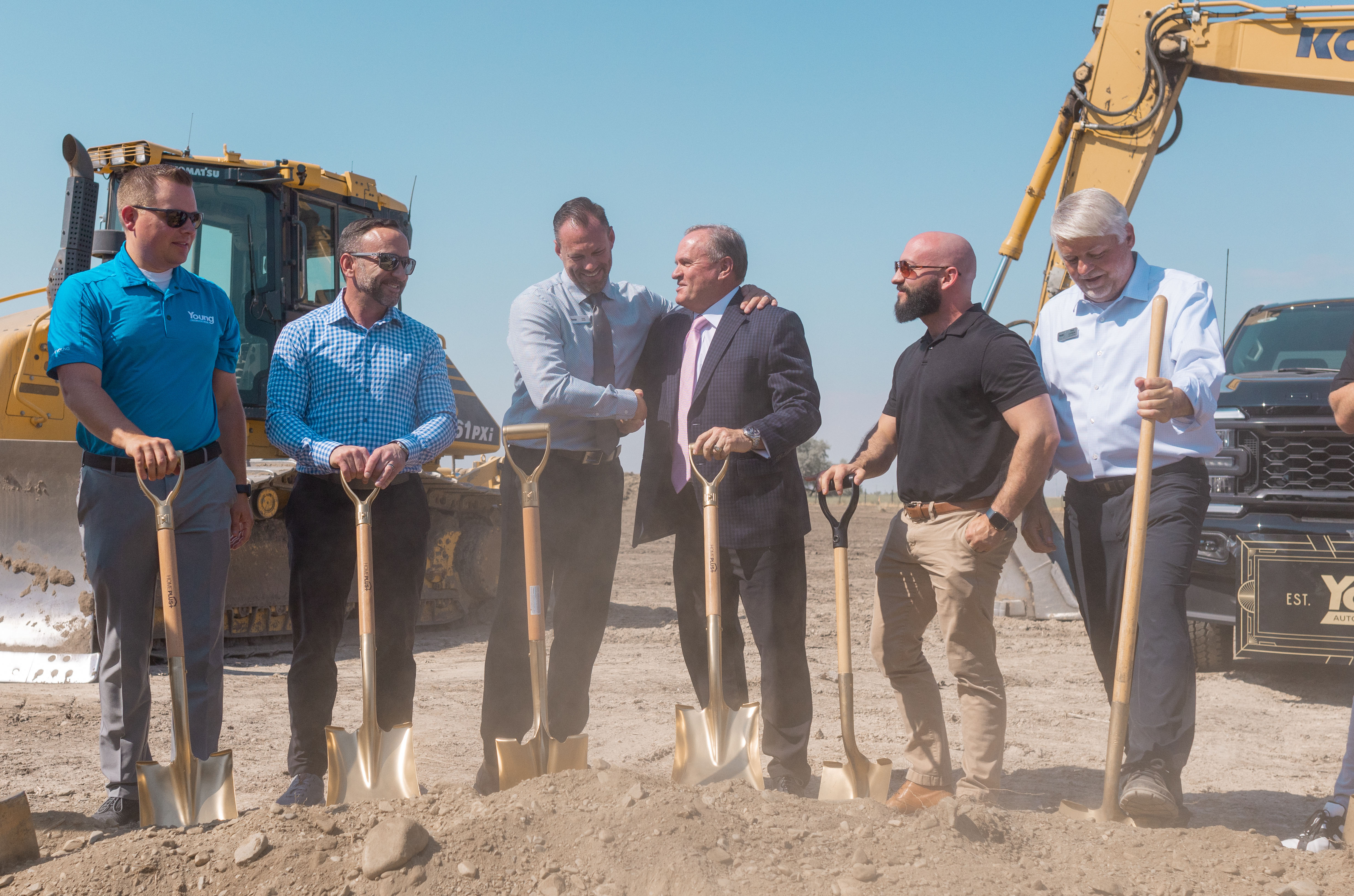 Young Ford Brigham City general manager Jason Evans (third from right) shakes hands with Spencer Young Sr. at groundbreaking for new facility.