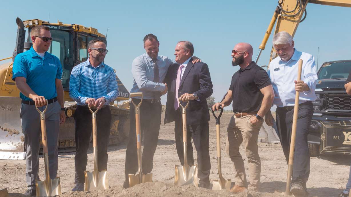 Young Ford Brigham City general manager Jason Evans (third from right) shakes hands with Spencer Young Sr. at groundbreaking for new facility.