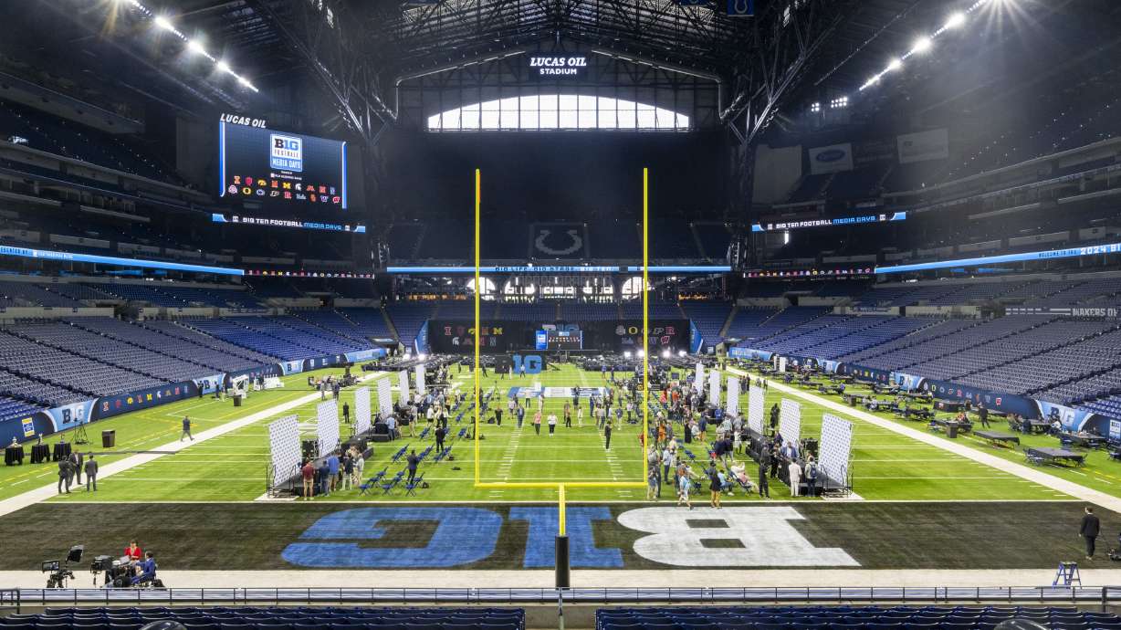 Players and coaches talk with reporters during an NCAA college football news conference at the Big Ten Conference media days at Lucas Oil Stadium, Wednesday, July 24, 2024, in Indianapolis.