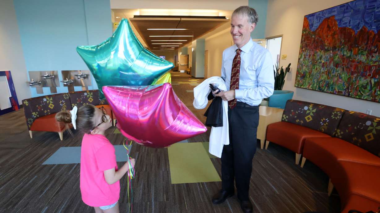 Scarlet Hill, 7, talks to Dr. Joshua Bonkowsky, University of Utah Health professor of pediatric neurology and medical director of the Center for Personalized Medicine at Primary Children’s Hospital on Friday.
