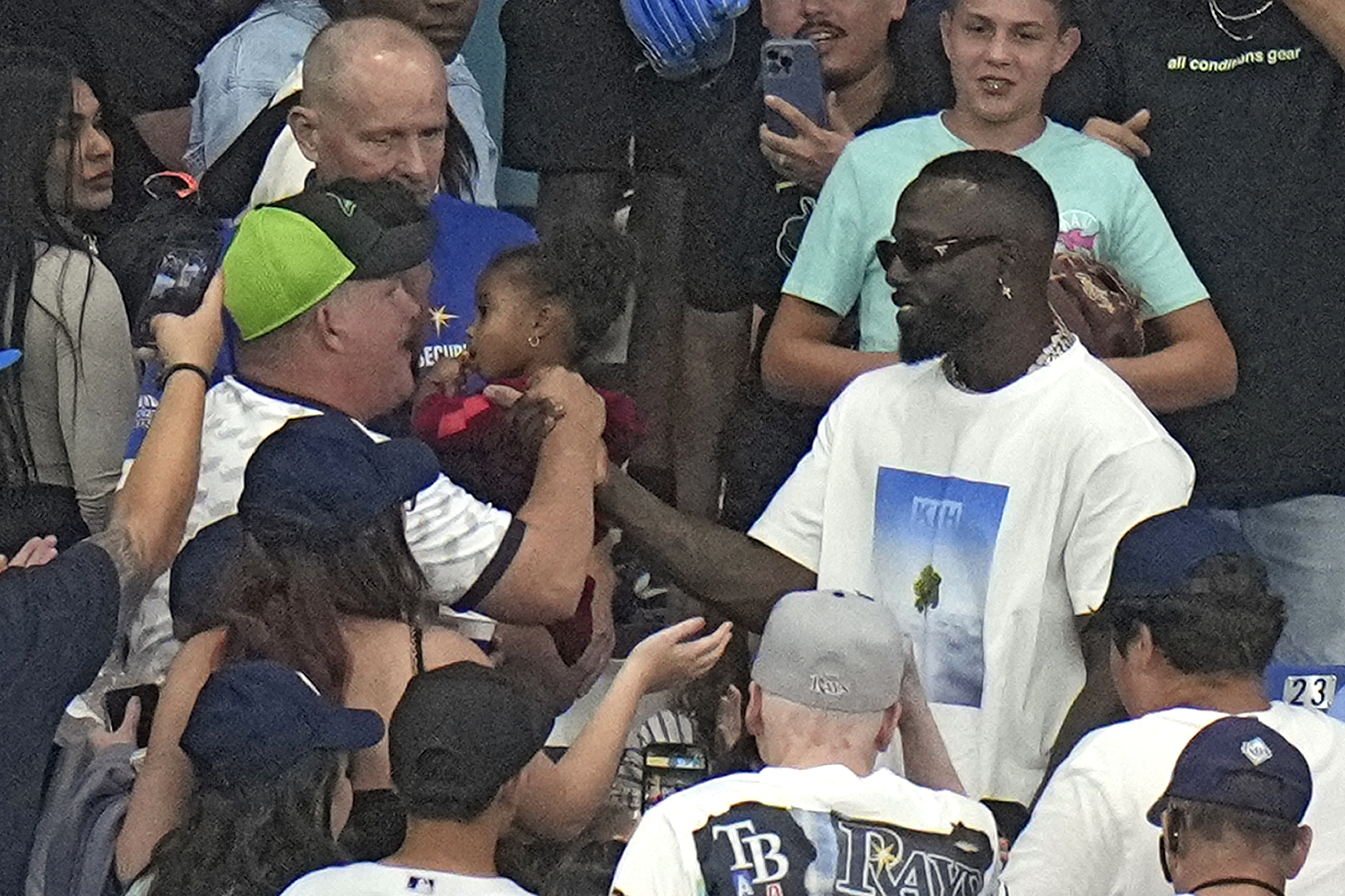 Former Tampa Bay Rays outfielder Randy Arozarena, right, shakes hands with fans during the fifth inning of a baseball game between the Rays and the Cincinnati Reds Friday, July 26, 2024, in St. Petersburg, Fla. Arozarena was traded to the Seattle Mariners earlier today.