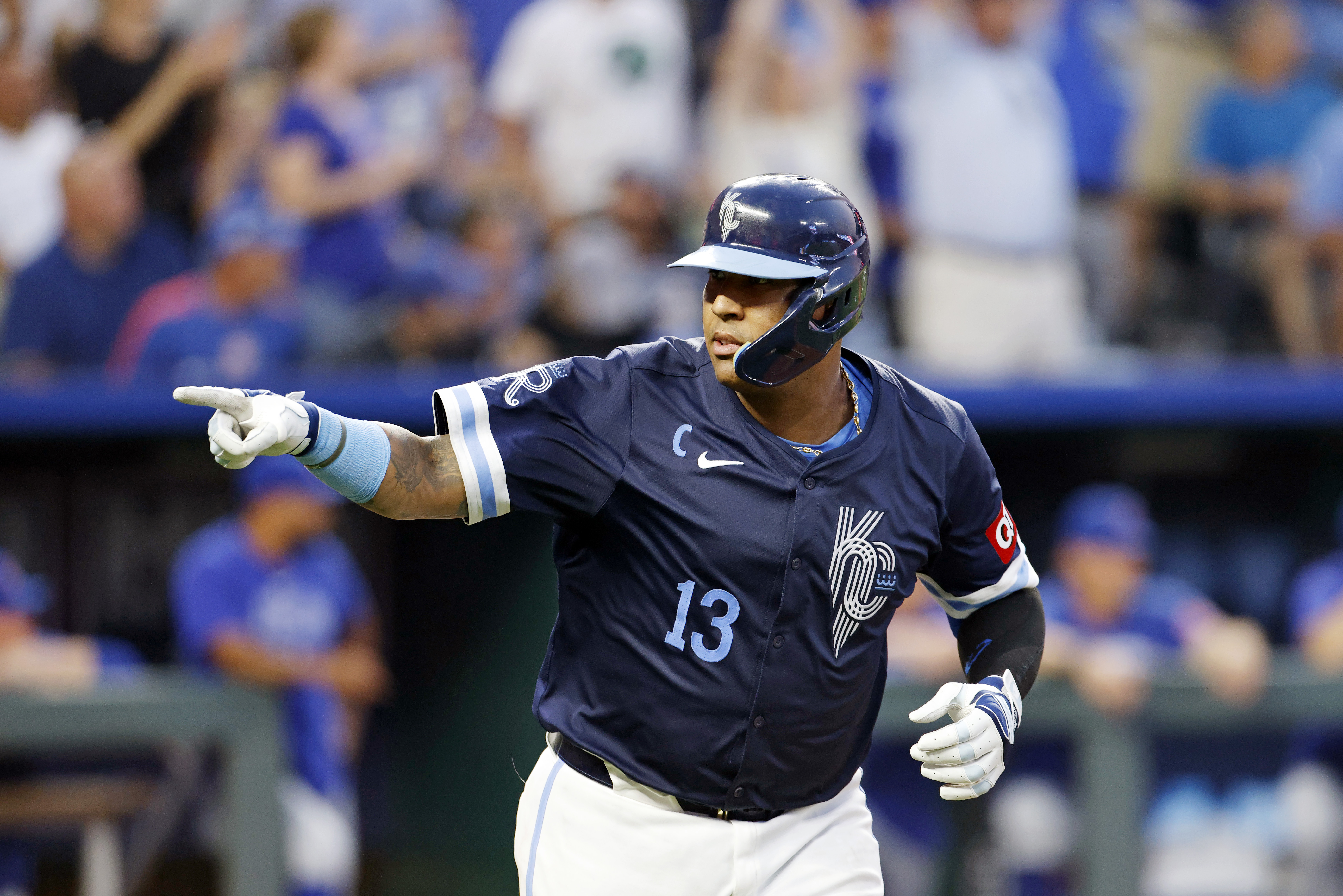 Kansas City Royals' Salvador Perez points toward the dugout as he celebrates after his three-run home run during the fifth inning of a baseball game against the Chicago Cubs in Kansas City, Mo., Friday, July 26, 2024.