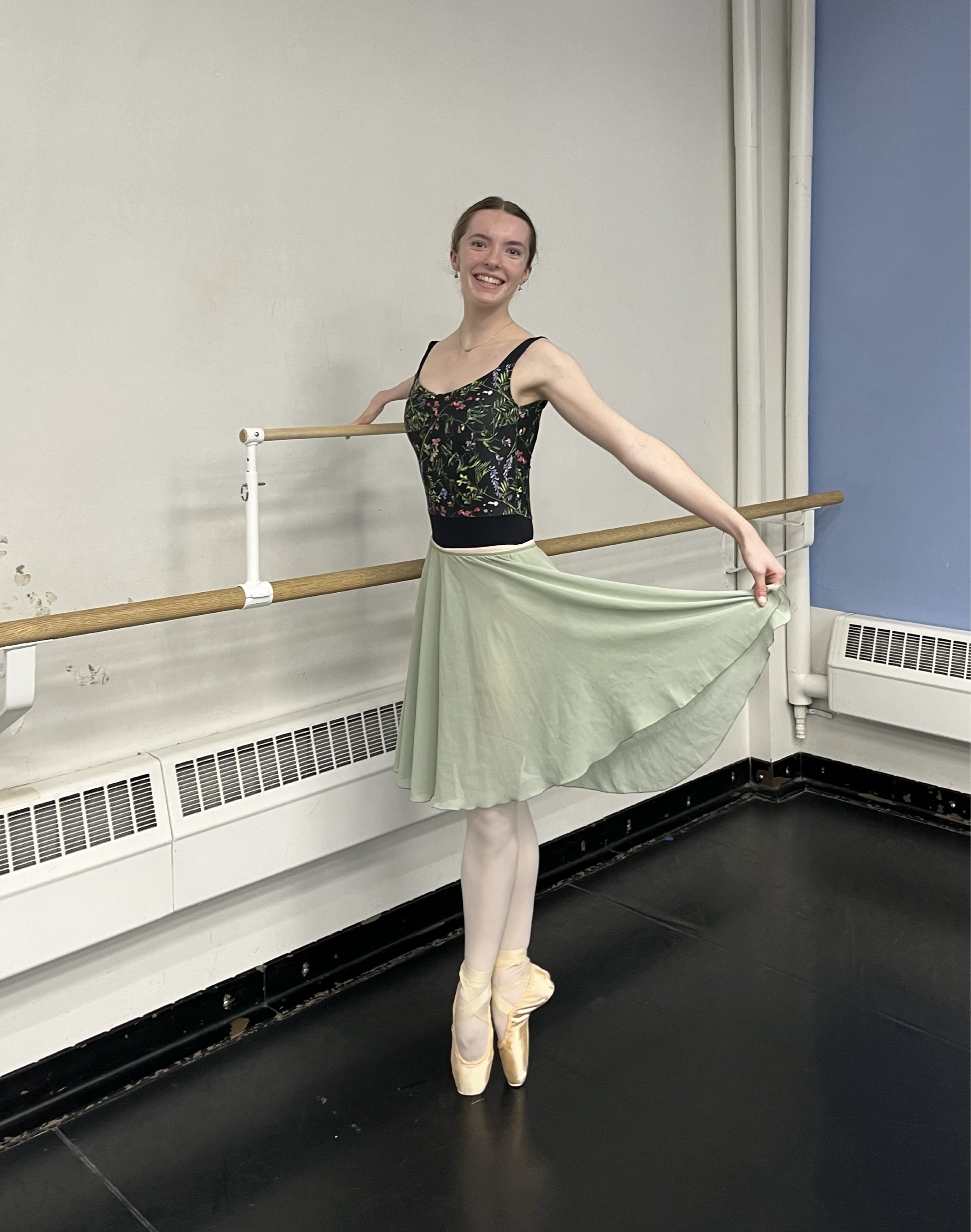 Ballet West II dancer Olivia Book uses a special barre attachment to help her in class.