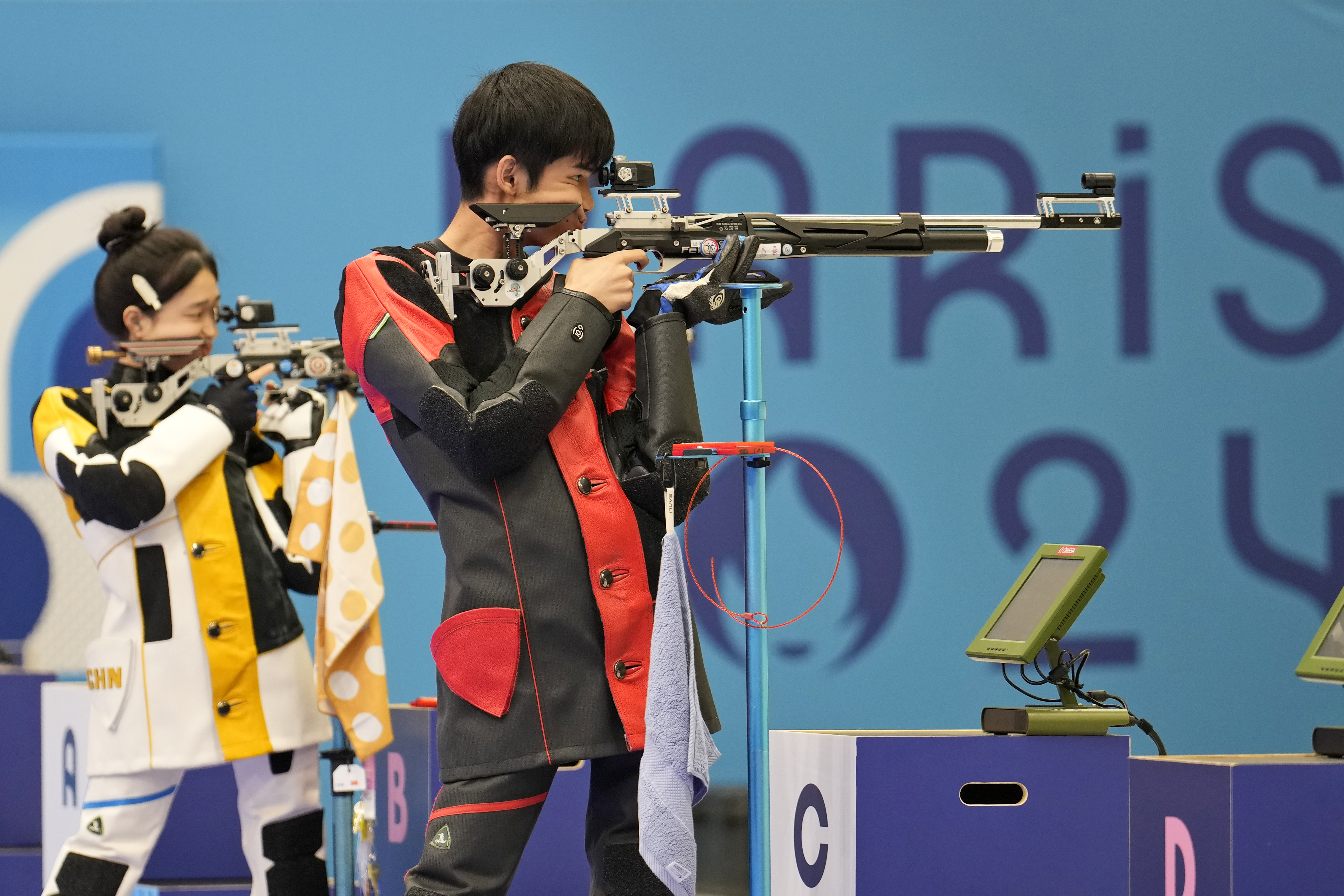 China's Sheng Lihao, right, and teammate Huang Yuting compete for the gold medal in the 10m air rifle mixed team medal round at the 2024 Summer Olympics, Saturday, July 27, 2024, in Chateauroux, France. 