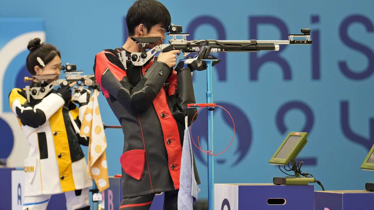 China's Sheng Lihao, right, and teammate Huang Yuting compete for the gold medal in the 10m air rifle mixed team medal round at the 2024 Summer Olympics, Saturday, July 27, 2024, in Chateauroux, France.