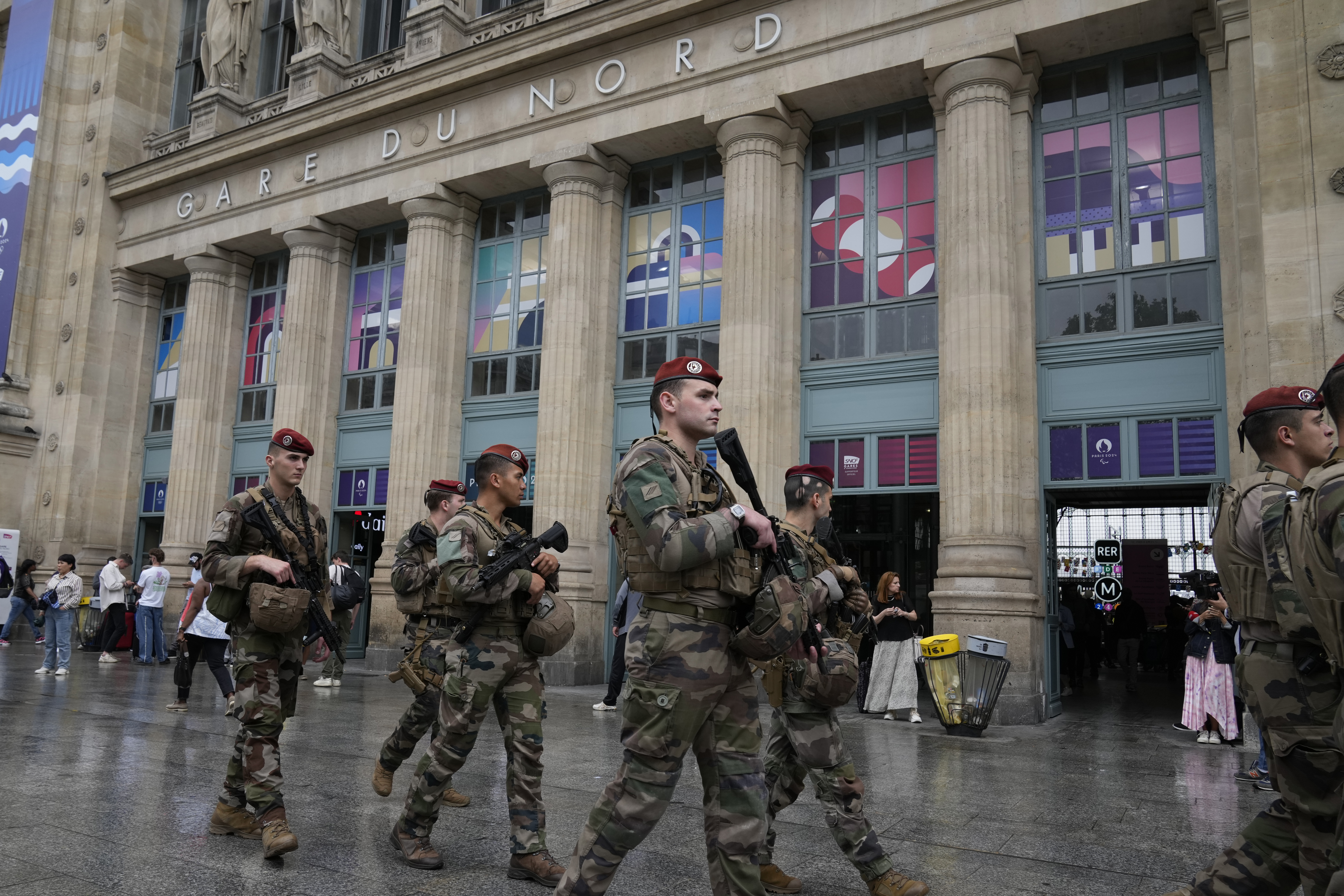 Soldiers patrol outside Gare du Nord train station at the 2024 Summer Olympics, Friday, July 26, 2024, in Paris, France. Hours away from the grand opening ceremony of the Olympics, high-speed rail traffic to the French capital was severely disrupted on Friday by what officials described as "criminal actions" and sabotage. 