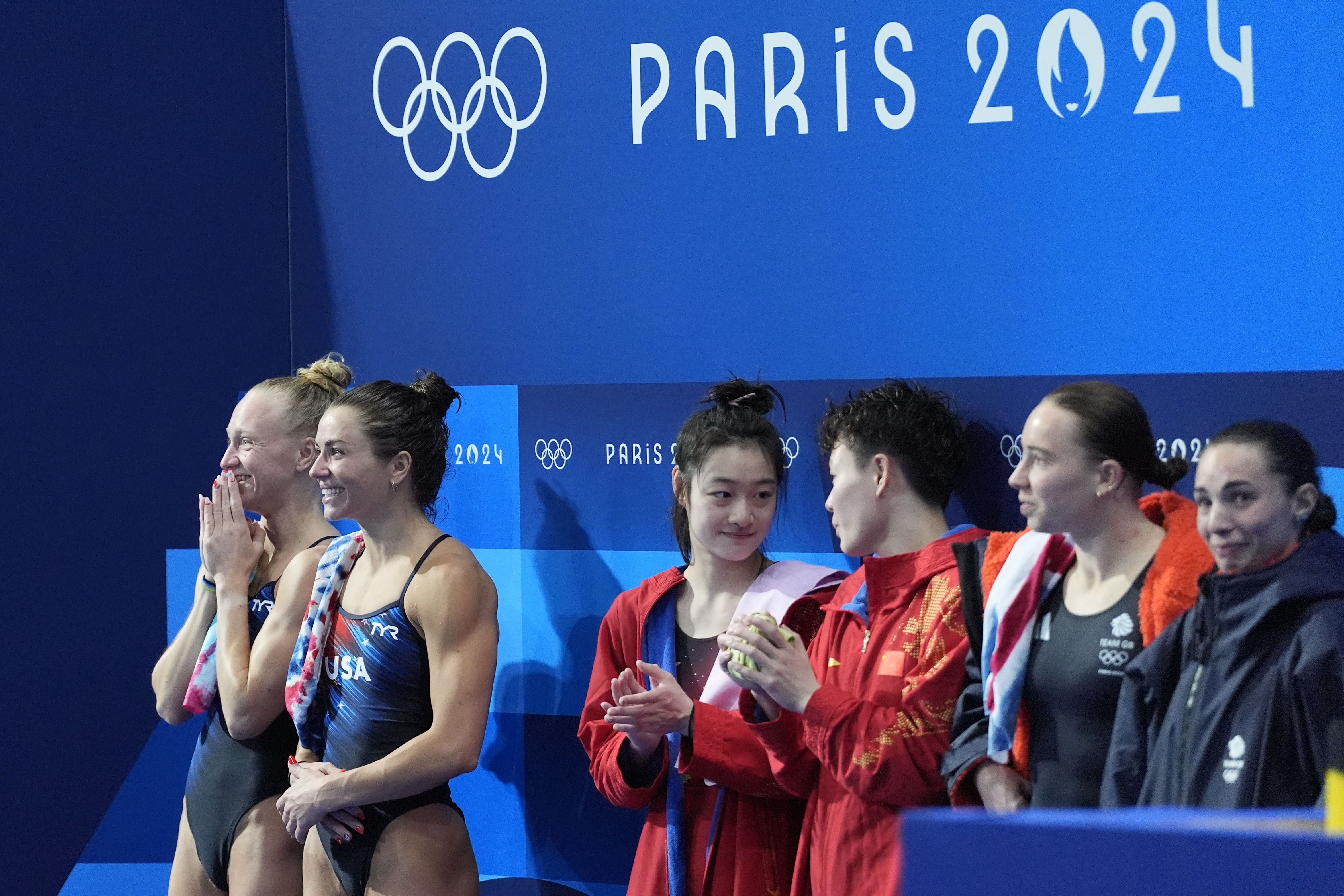 United States' Sarah Bacon and Kassidy Cook celebrate after winning the silver medal flanked by gold medal China's Chen Yiwen and Chang Yani and bronze medal Britain's Yasmin Harper and Scarlett Mew Jensen in the women's synchronised 3m springboard diving final at the 2024 Summer Olympics, Saturday, July 27, 2024, in Saint-Denis, France. 