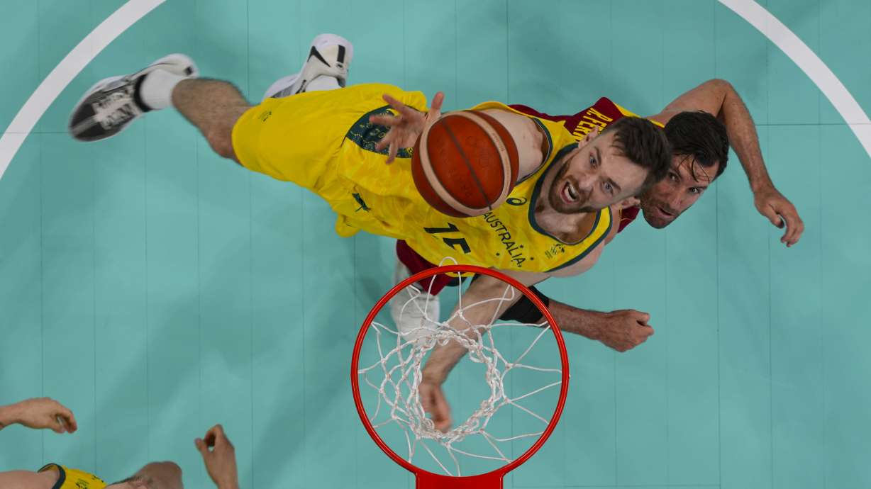 Nick Kay, of Australia, shoots over Rudy Fernández, of Spain, during a men's basketball game at the 2024 Summer Olympics, Saturday, July 27, 2024, in Lille, France.