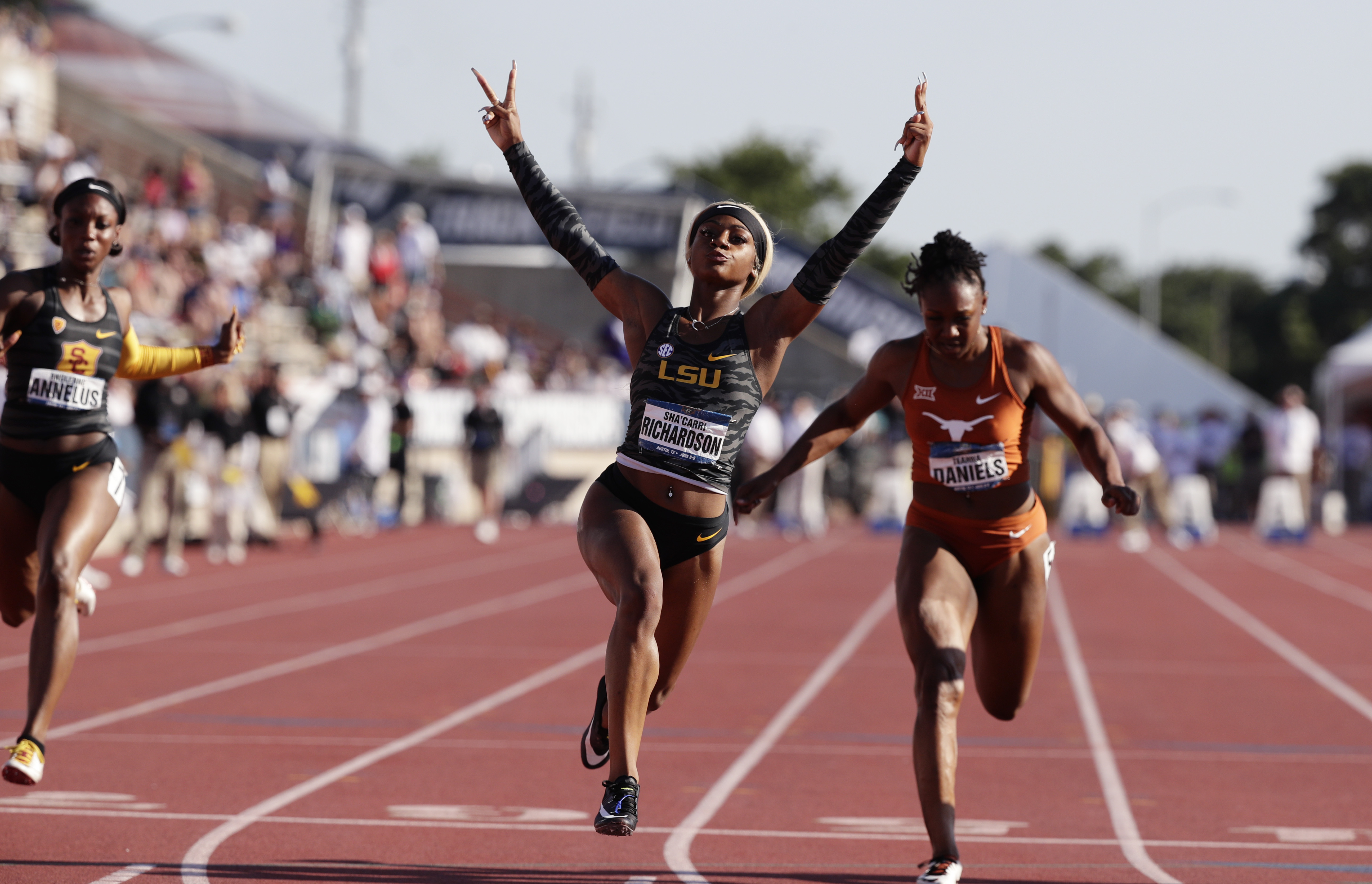 FILE - LSU's Sha'Carri Richardson, center, celebrates as she wins the women's 100 meters during the NCAA outdoor track and field championships in Austin, Texas, June 8, 2019.