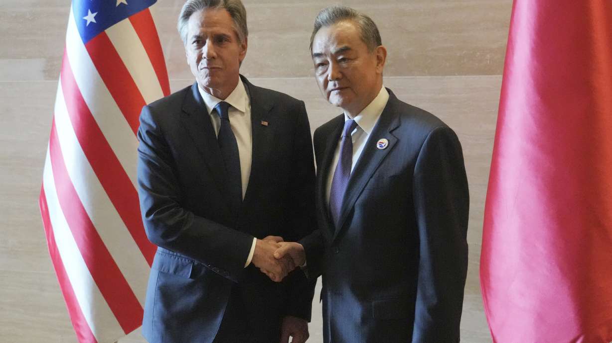 U.S. Secretary of State Antony Blinken, left, shakes hands with Chinese counterpart Wang Yi on the sideline of the Association of Southeast Asian Nations Foreign Ministers' Meeting in Vientiane, Laos, Saturday.