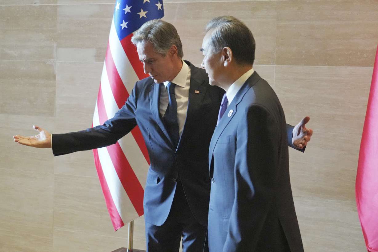 U.S. Secretary of State Antony Blinken, left, gestures to Chinese counterpart Wang Yi on the sideline of the Association of Southeast Asian Nations Foreign Ministers' Meeting in Vientiane, Laos, Saturday.