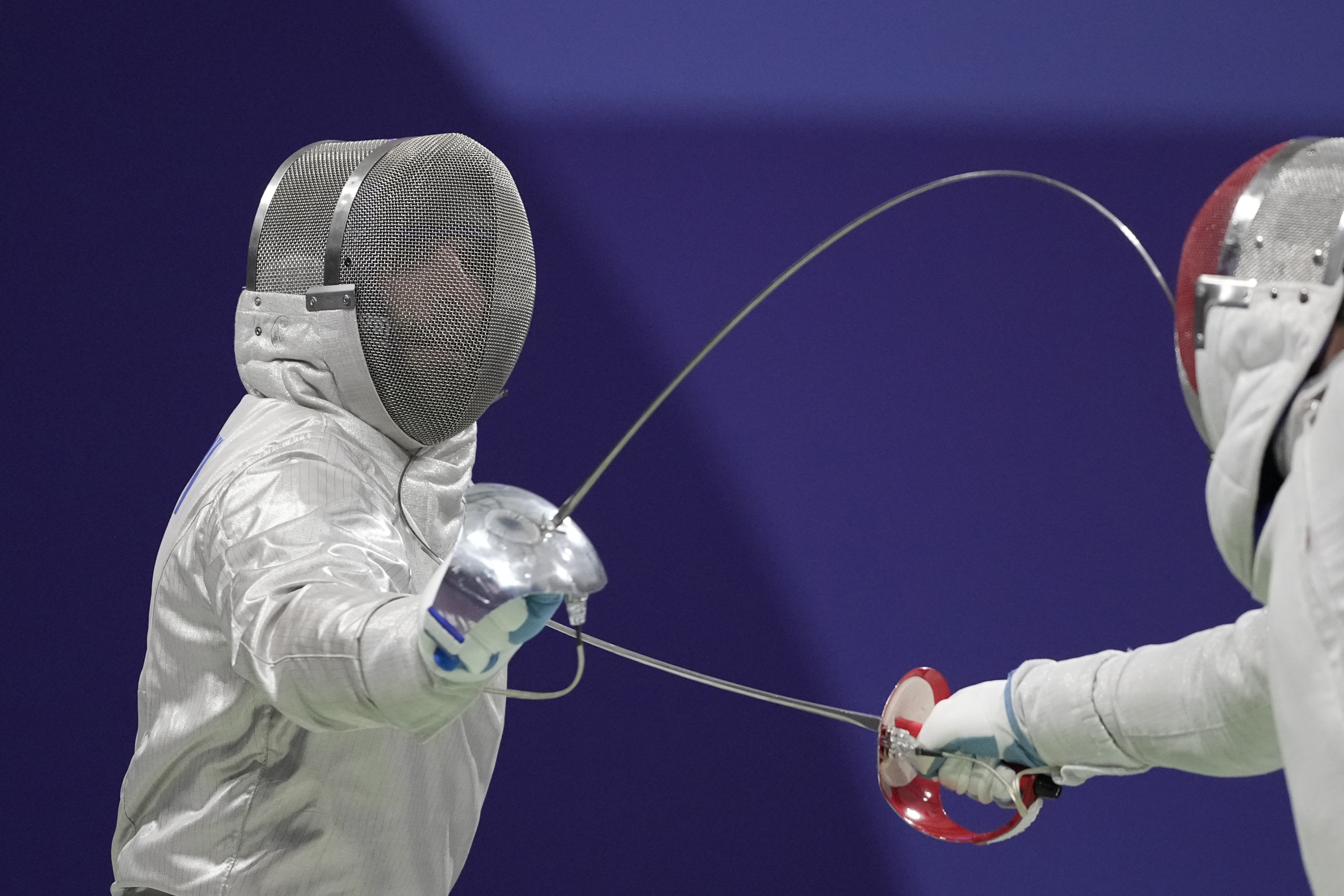 Hungary's Aron Szilagyi, left, and Canada's Fares Arfa compete in the men's individual Sabre round of 32 competition during the 2024 Summer Olympics at the Grand Palais, Saturday, July 27, 2024, in Paris, France.