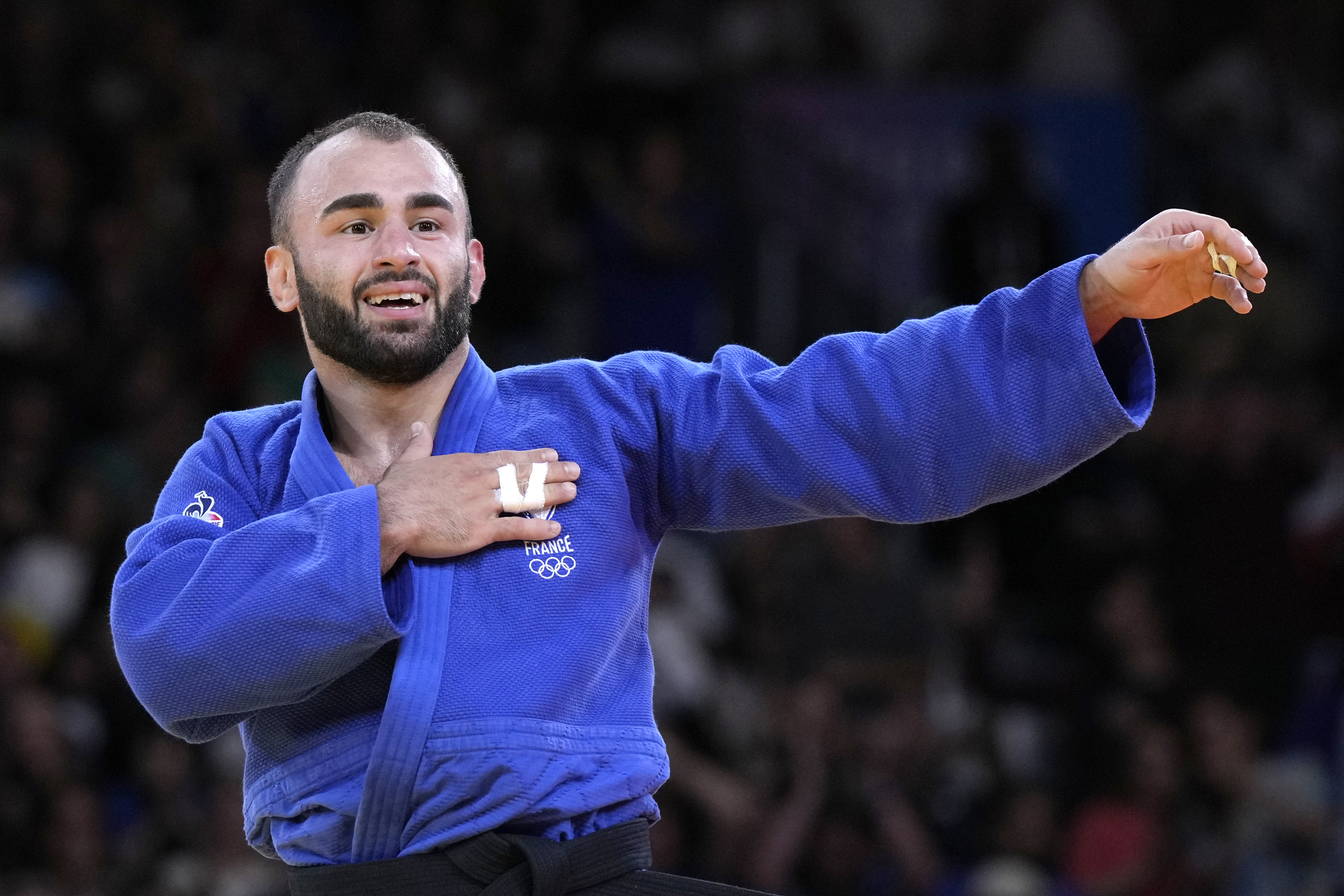 France's Luka Mkheidze celebrates after defeating Turkey's Salih Yildiz during their men -60 kg semifinal match in team judo competition at Champ-de-Mars Arena during the 2024 Summer Olympics, Saturday, July 27, 2024, in Paris, France. 