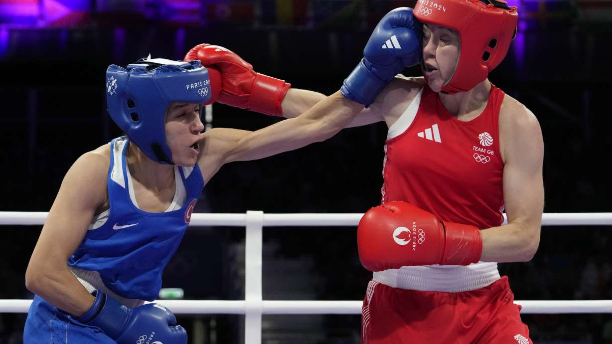 Turkey's Hatice Akbas lands a left to Britain's Charley Davison in their women's 54 kg preliminary boxing match at the 2024 Summer Olympics, Saturday, July 27, 2024, in Paris, France.