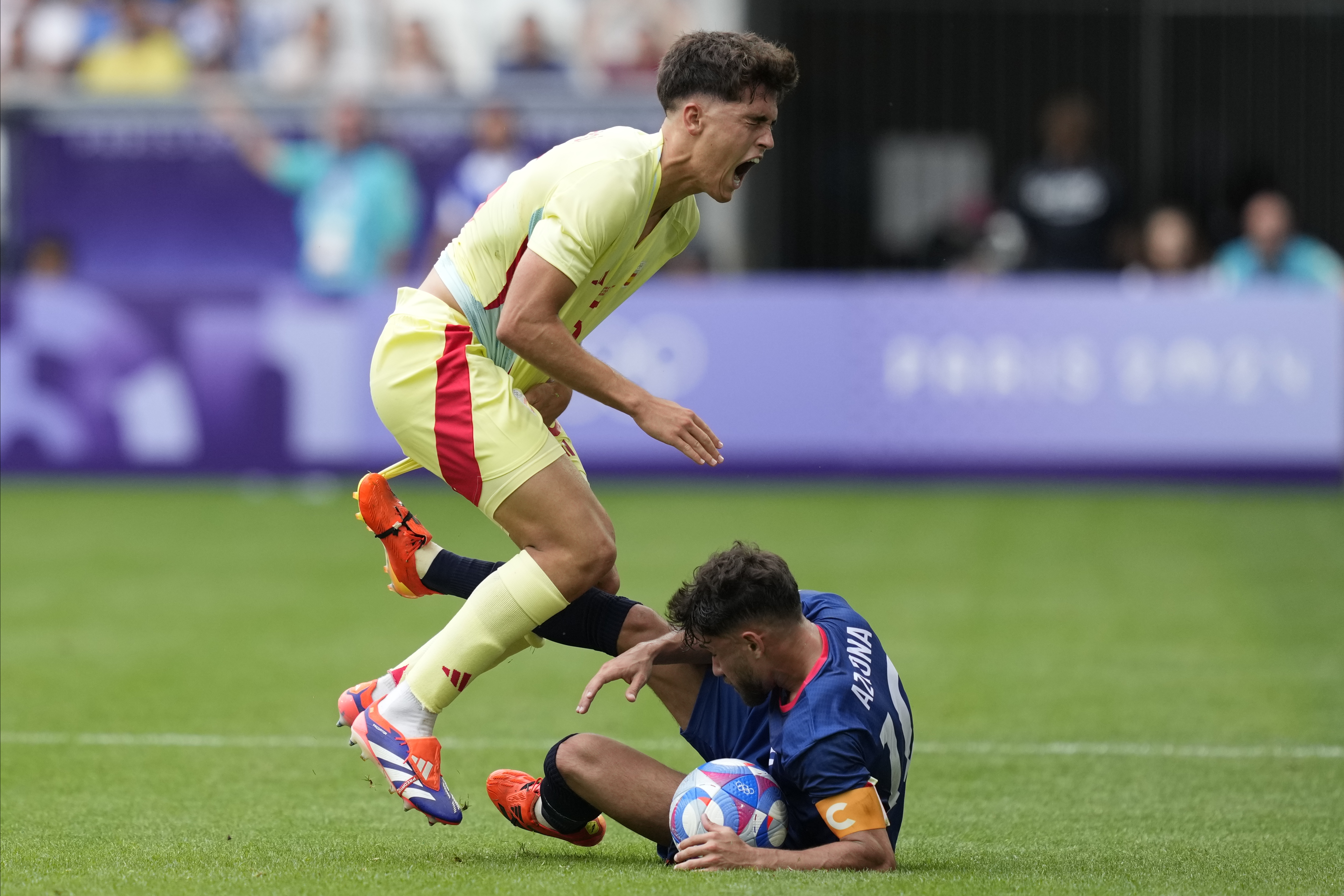 Spain'sPau Cubarsi, left, is fouled by Dominican Republic's Edison Azcona during the men's Group C soccer match at the Bordeaux stadium at the 2024 Summer Olympics, Saturday, July 27, 2024, in Bordeaux, France. 