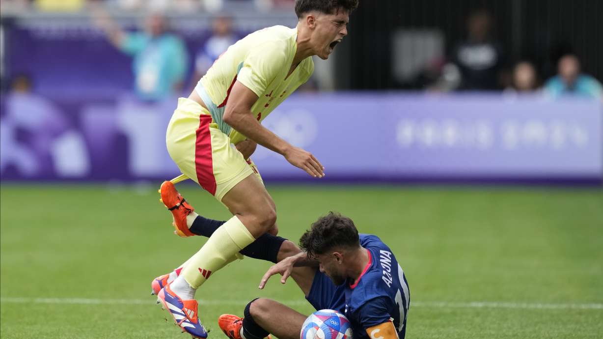 Spain'sPau Cubarsi, left, is fouled by Dominican Republic's Edison Azcona during the men's Group C soccer match at the Bordeaux stadium at the 2024 Summer Olympics, Saturday, July 27, 2024, in Bordeaux, France.