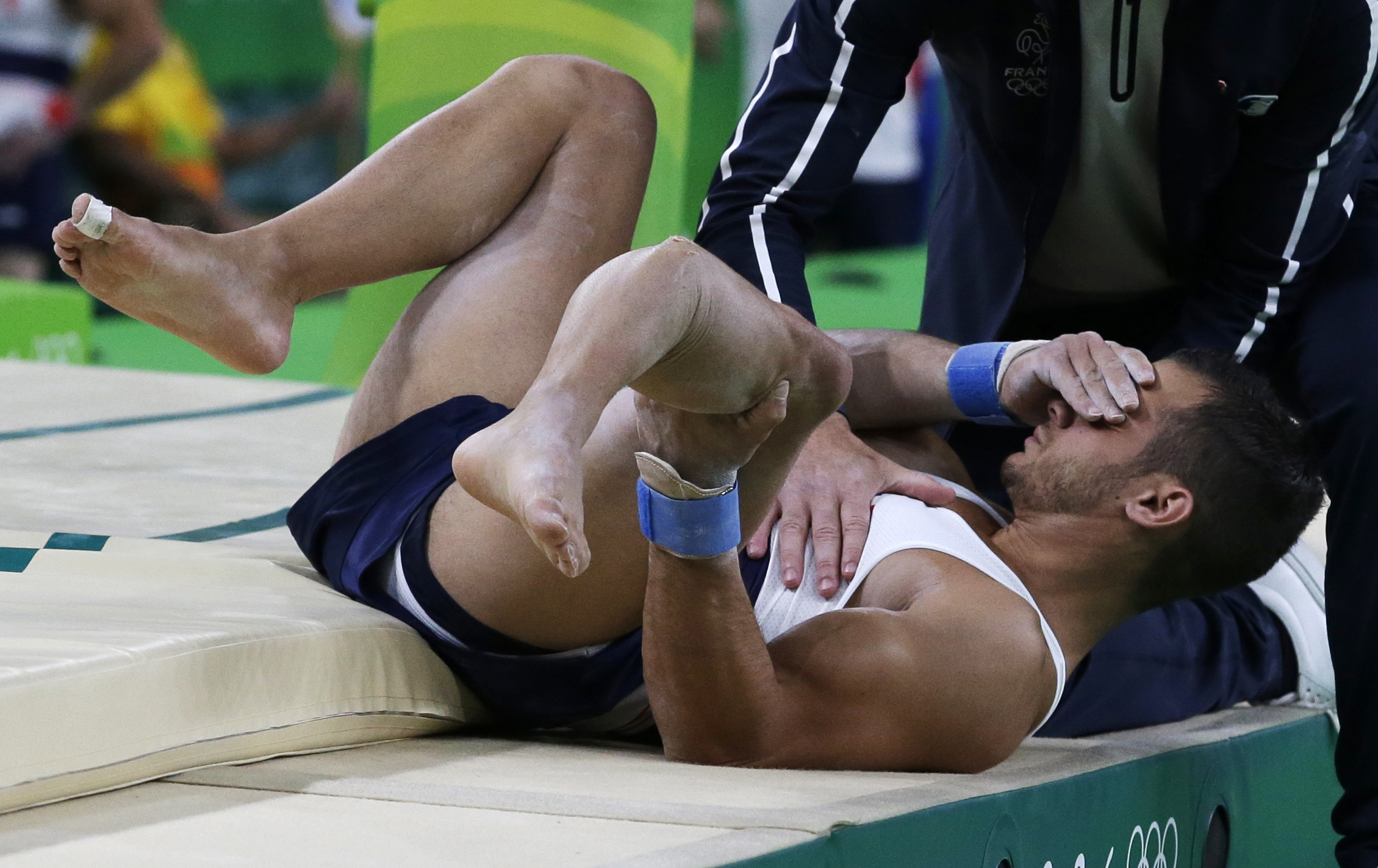 FILE - France's Samir Ait Said holds his leg after injuring it while performing on the vault during the artistic gymnastics men's qualification at the 2016 Summer Olympics in Rio de Janeiro, Brazil, Aug. 6, 2016. 