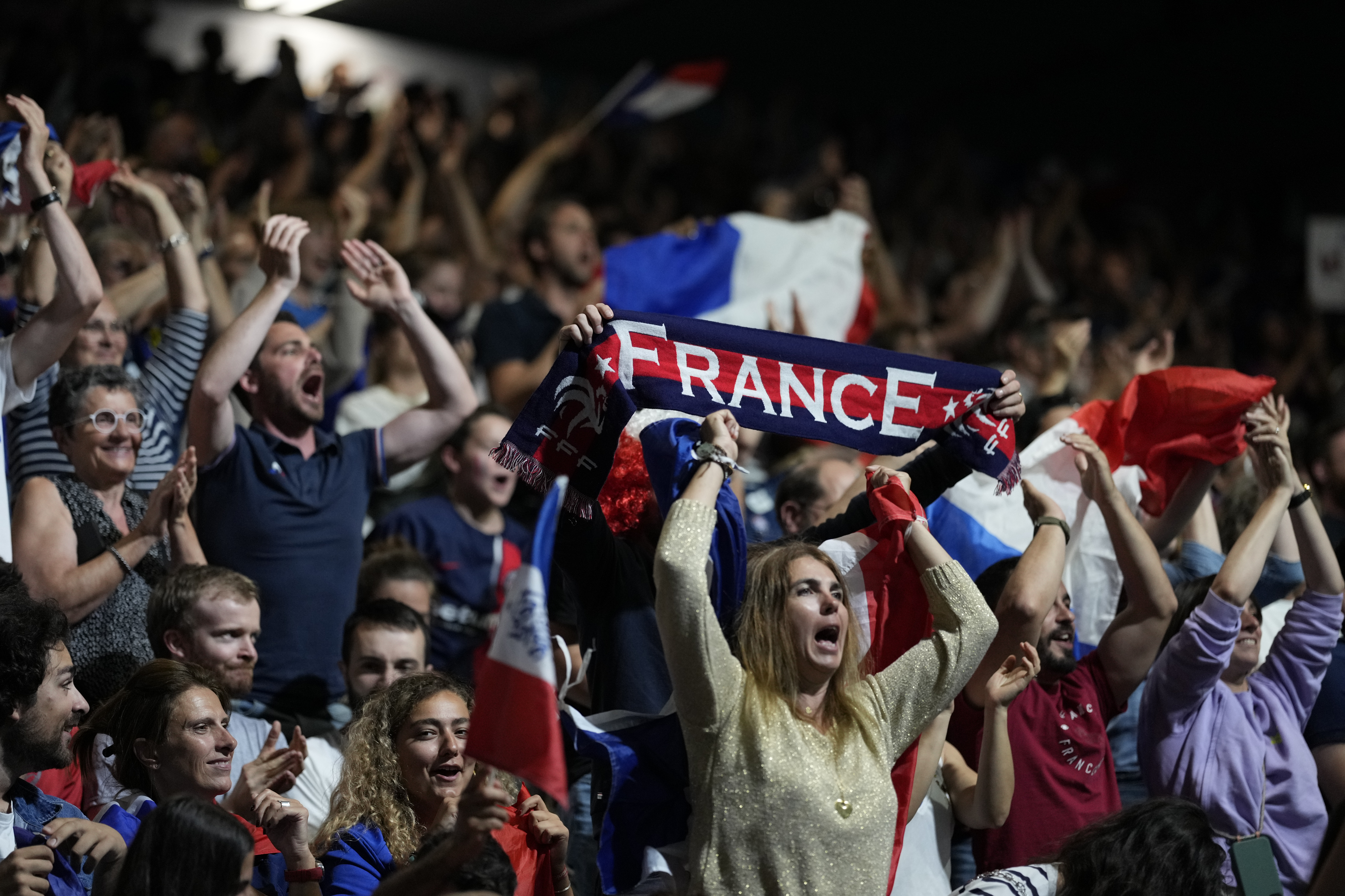 French supporters cheer for their team against Denmark at a men's handball match at the 2024 Summer Olympics, Saturday, July 27, 2024, in Paris, France. 