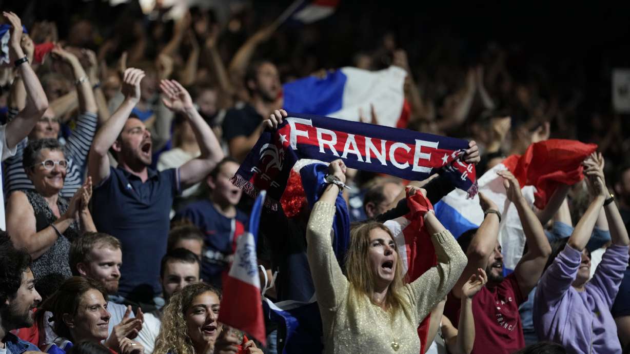 French supporters cheer for their team against Denmark at a men's handball match at the 2024 Summer Olympics, Saturday, July 27, 2024, in Paris, France.
