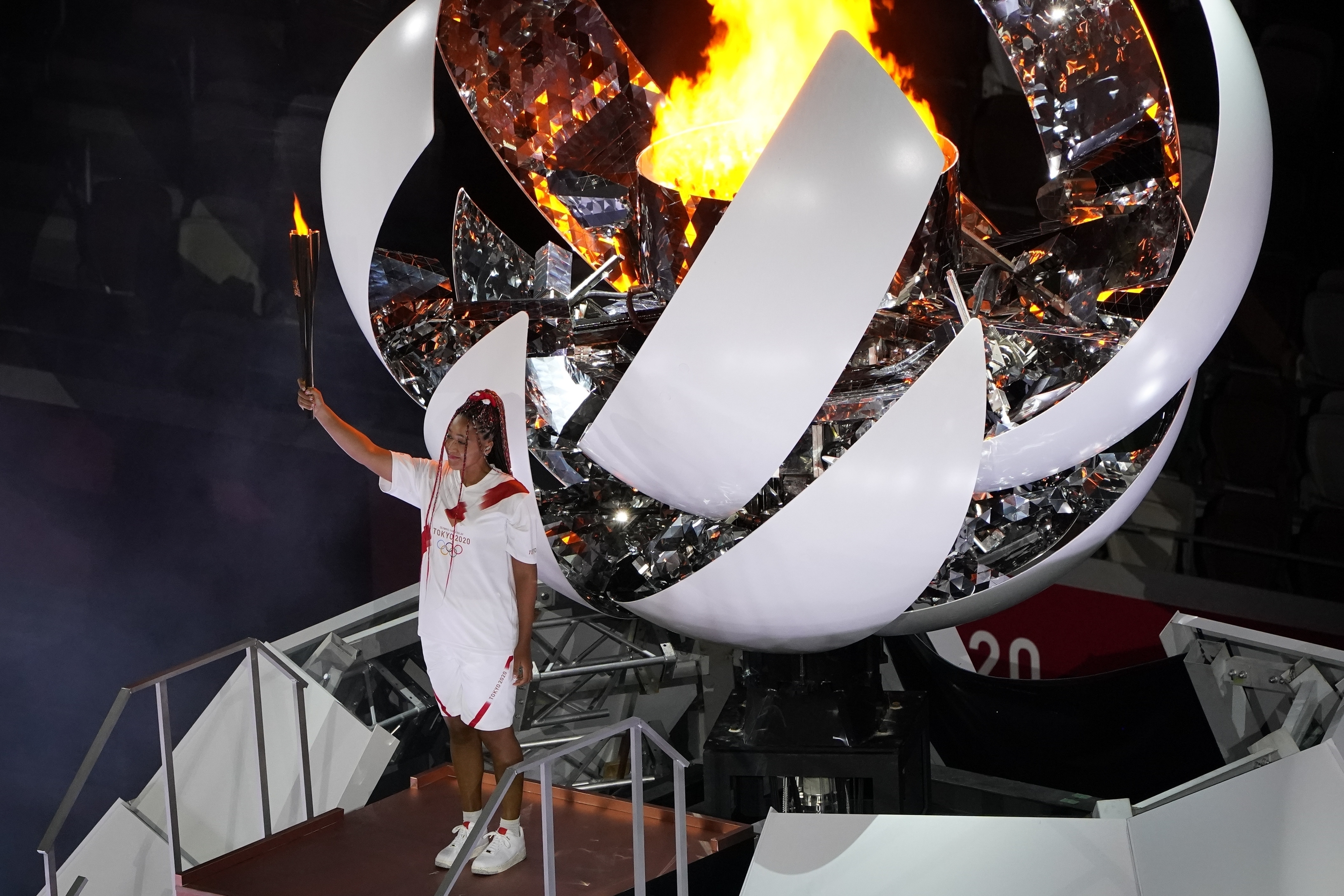FILE - Naomi Osaka lights the Olympic cauldron during the opening ceremony at the Olympic Stadium at the 2020 Summer Olympics, July 23, 2021, in Tokyo. 
