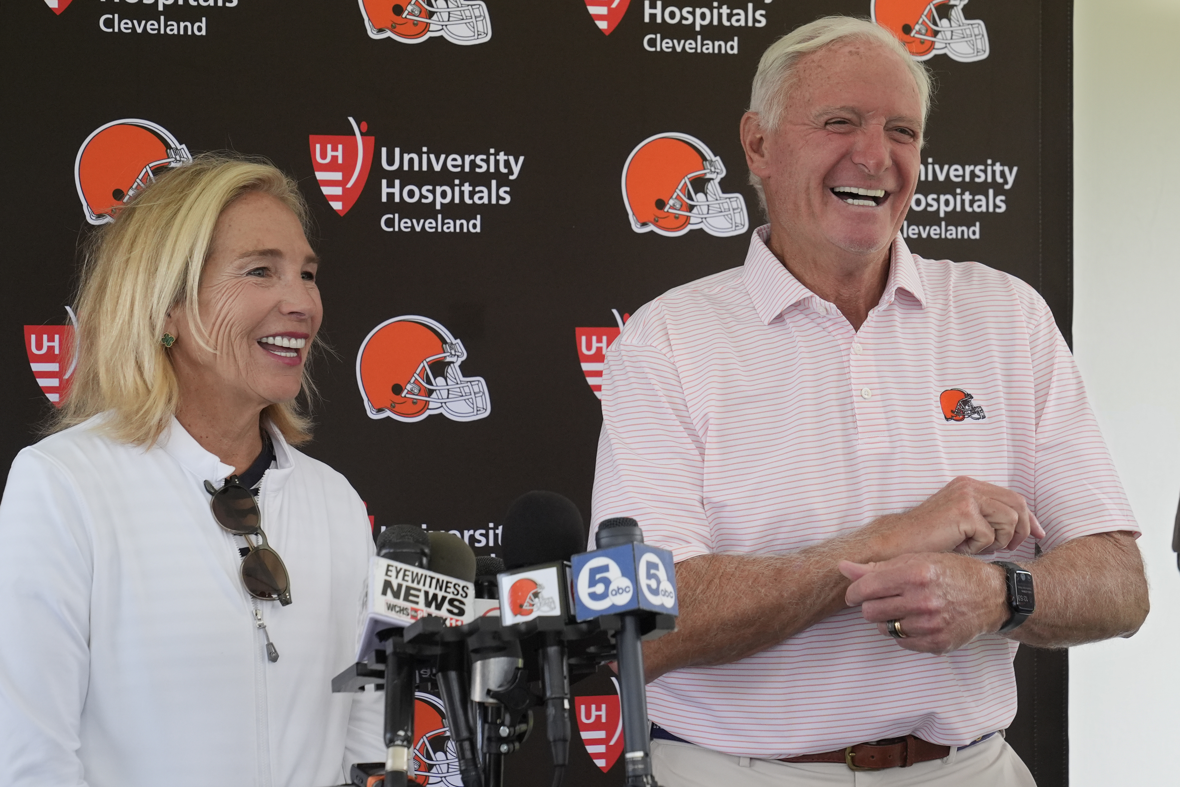 Cleveland Browns owners Dee and Jimmy Haslam laugh during a news conference at an NFL football training camp practice, Saturday, July 27, 2024, in White Sulphur Springs, W.Va. 