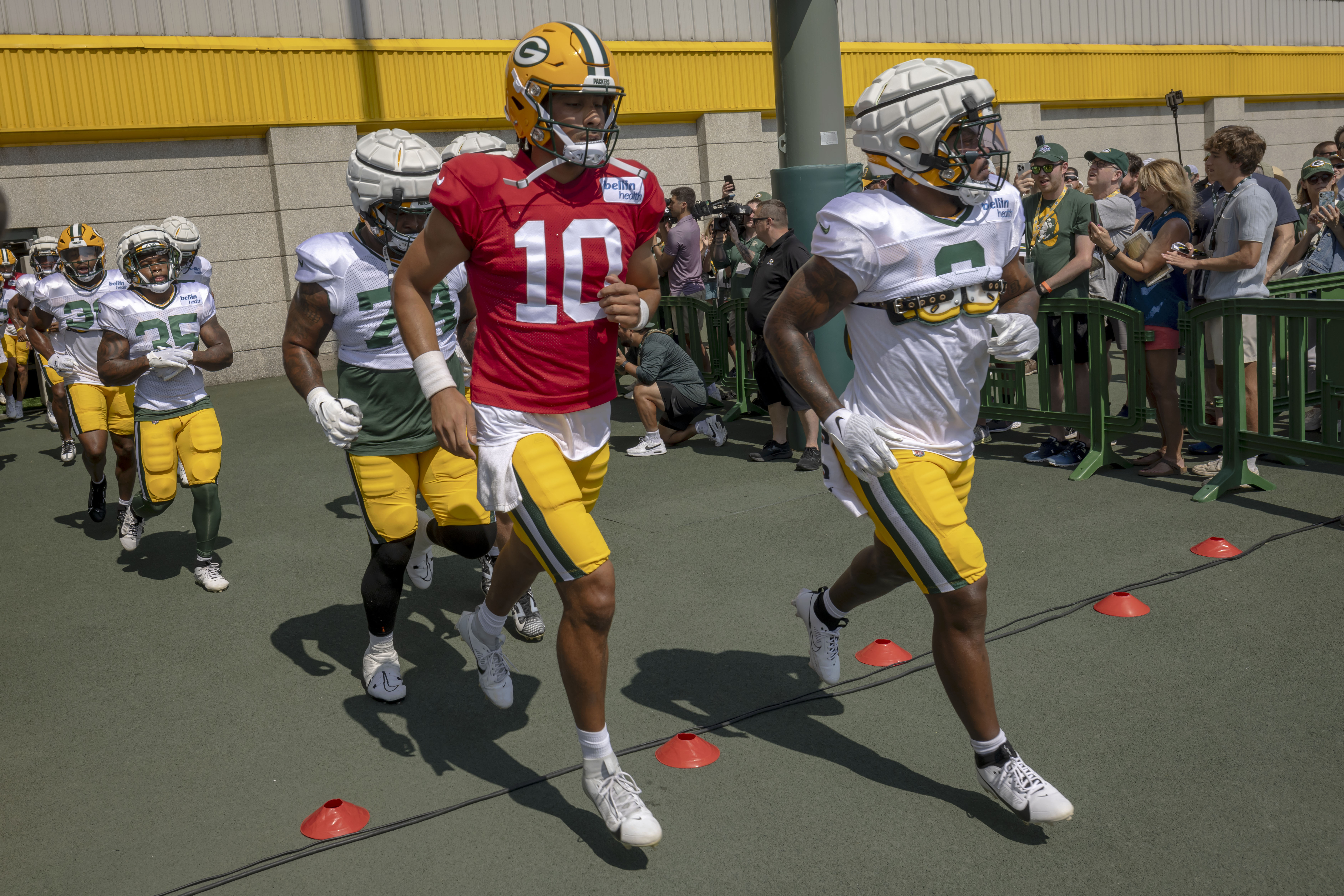 Green Bay Packers' Jordan Love (10) runs out on to the practice field during an NFL football training camp, Saturday, July 27, 2024, in Green Bay, Wis. 
